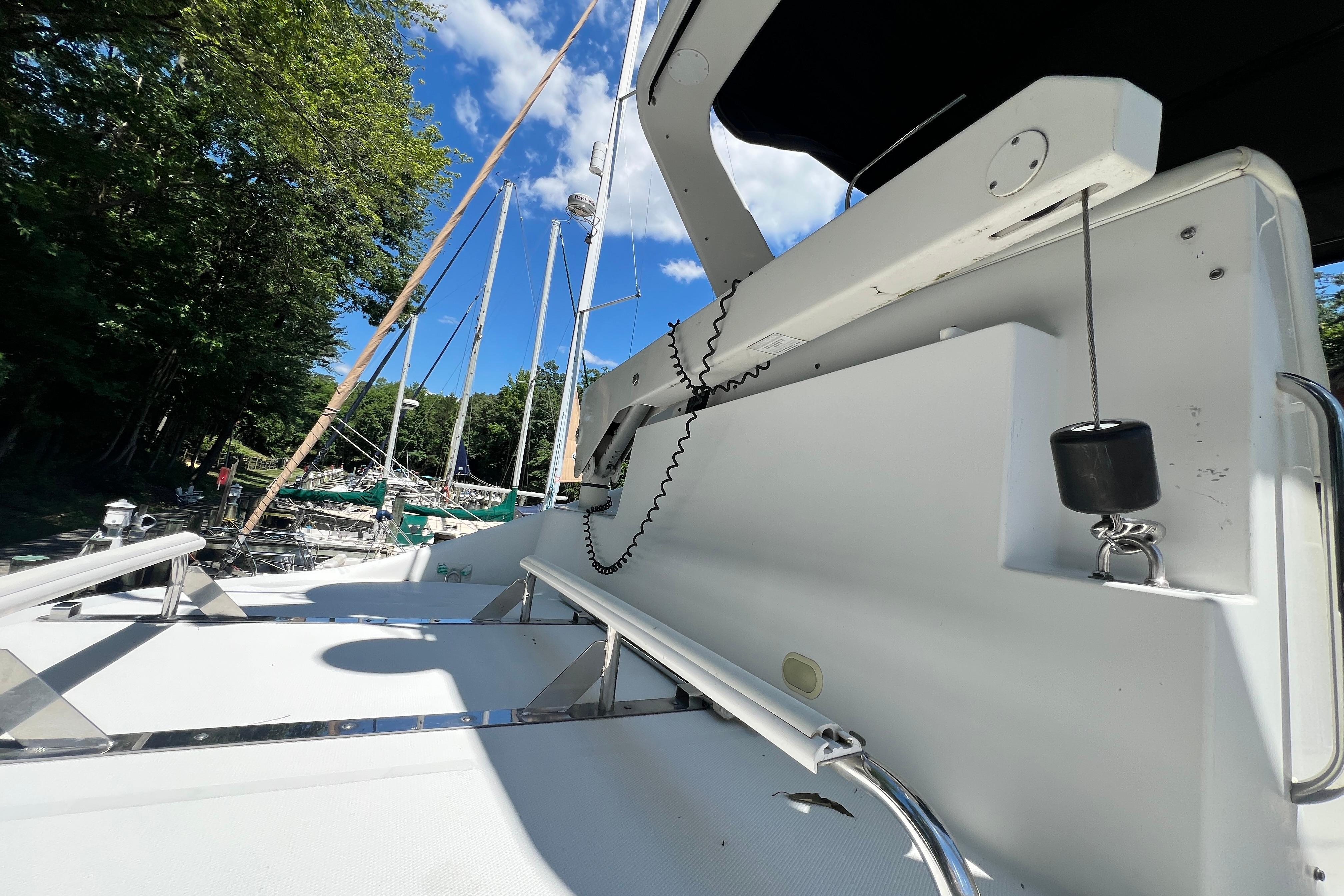 2003 Carver 450 Voyager Pilothouse yacht deck with clear sky and marina view.
