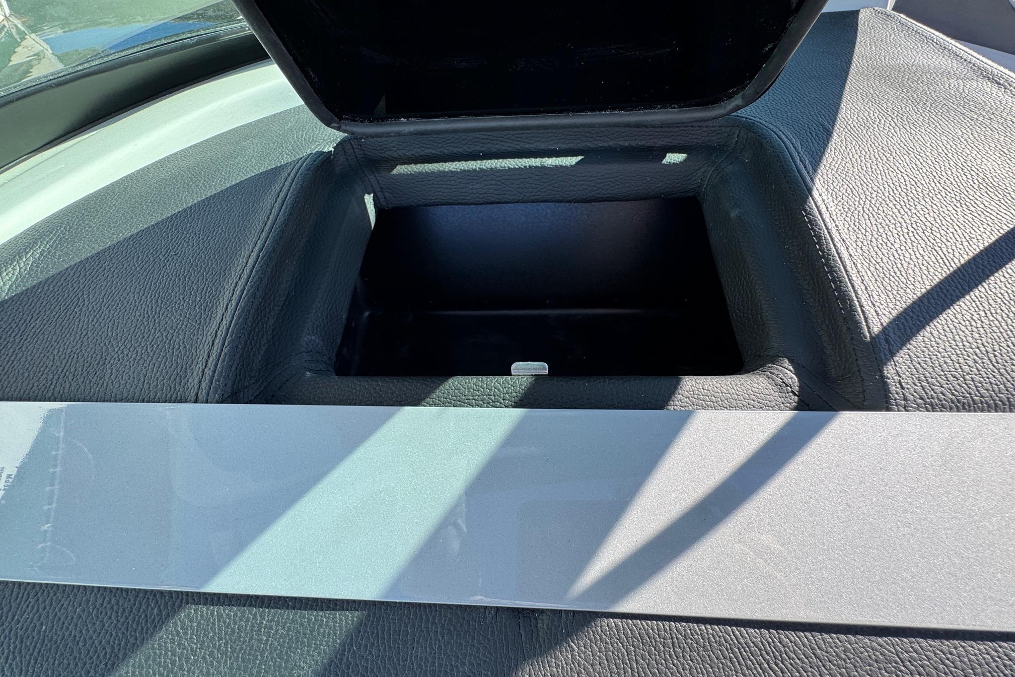 Open storage compartment in 2026 Regal 21 OBX boat dashboard.