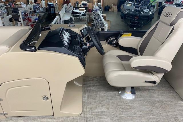 2026 Bentley Pontoons Legacy 223 Navigator helm with beige captain's chair and control panel.