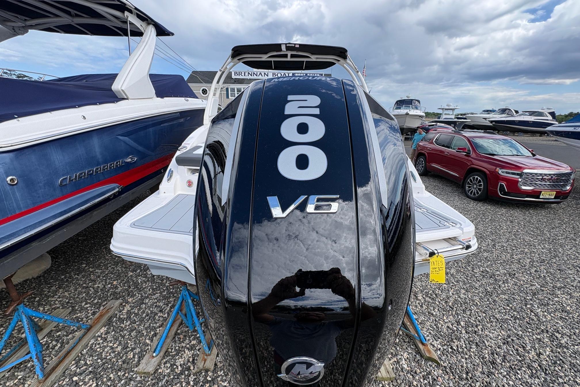 Chaparral 23 SSi OB 2026 boat with V6 engine displayed outdoors.