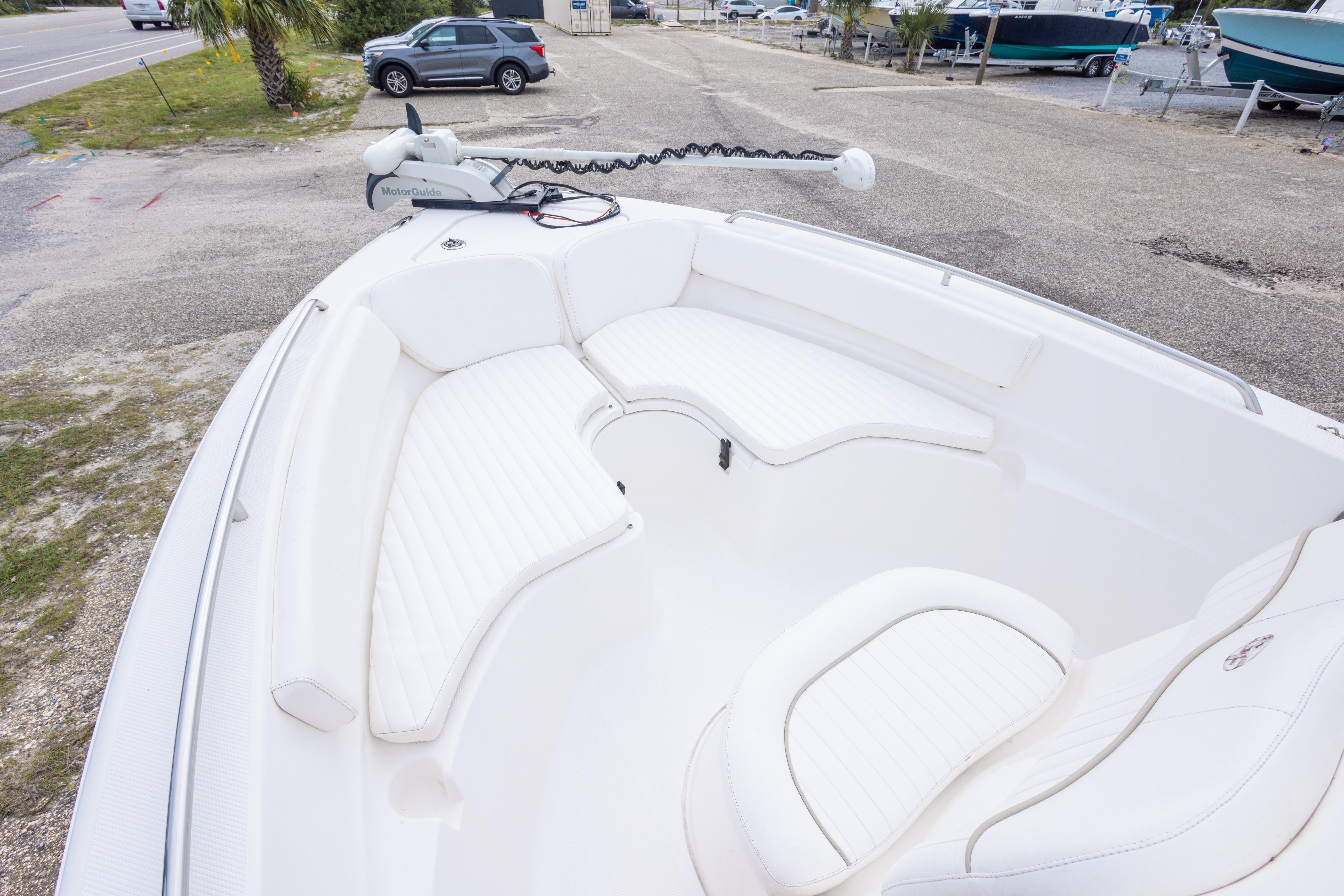 2014 Sea Fox 209 Commander boat with white seating and trolling motor.