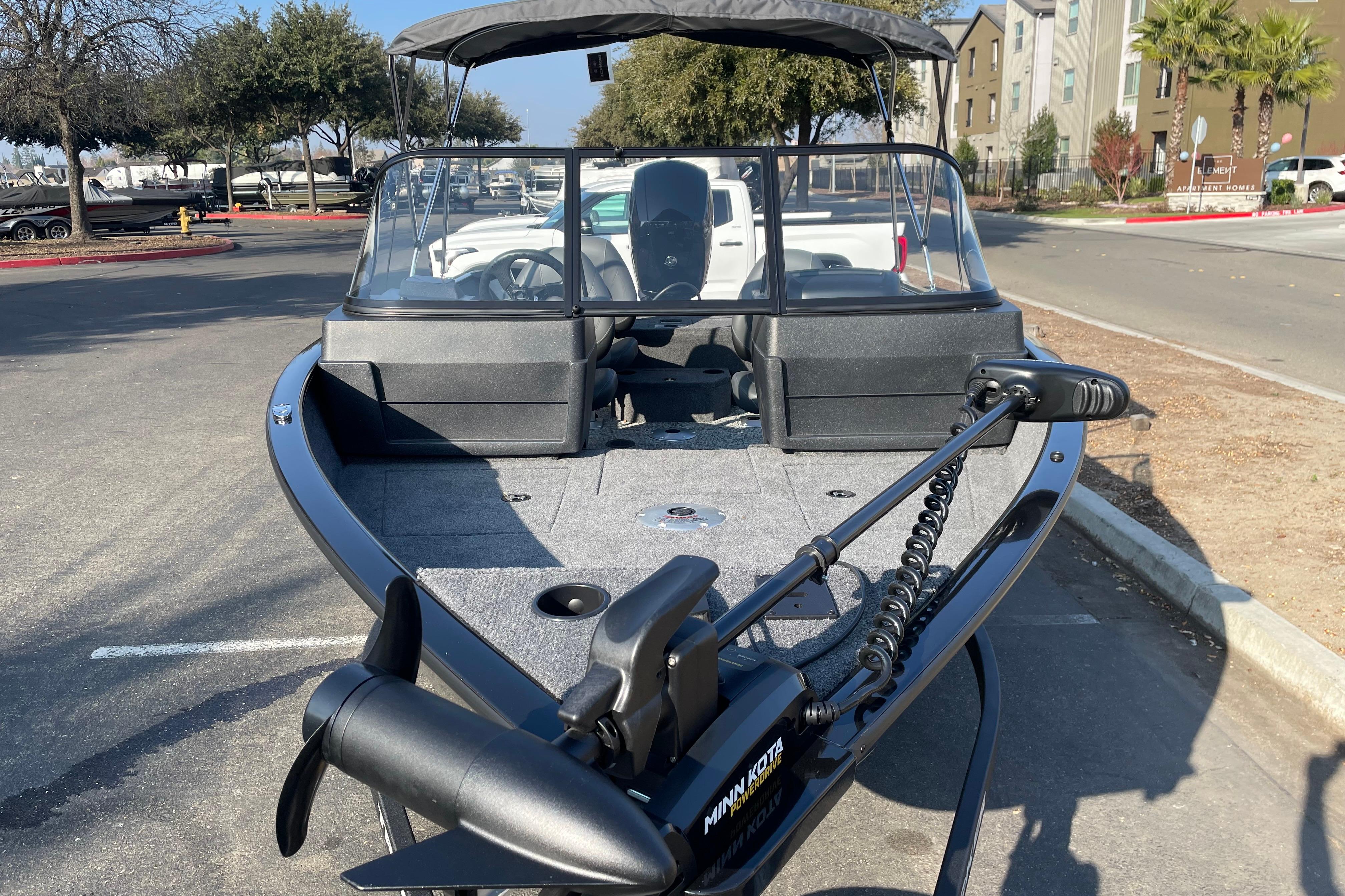 2026 Tracker Pro Guide V-175 WT boat with Minn Kota trolling motor in parking lot.