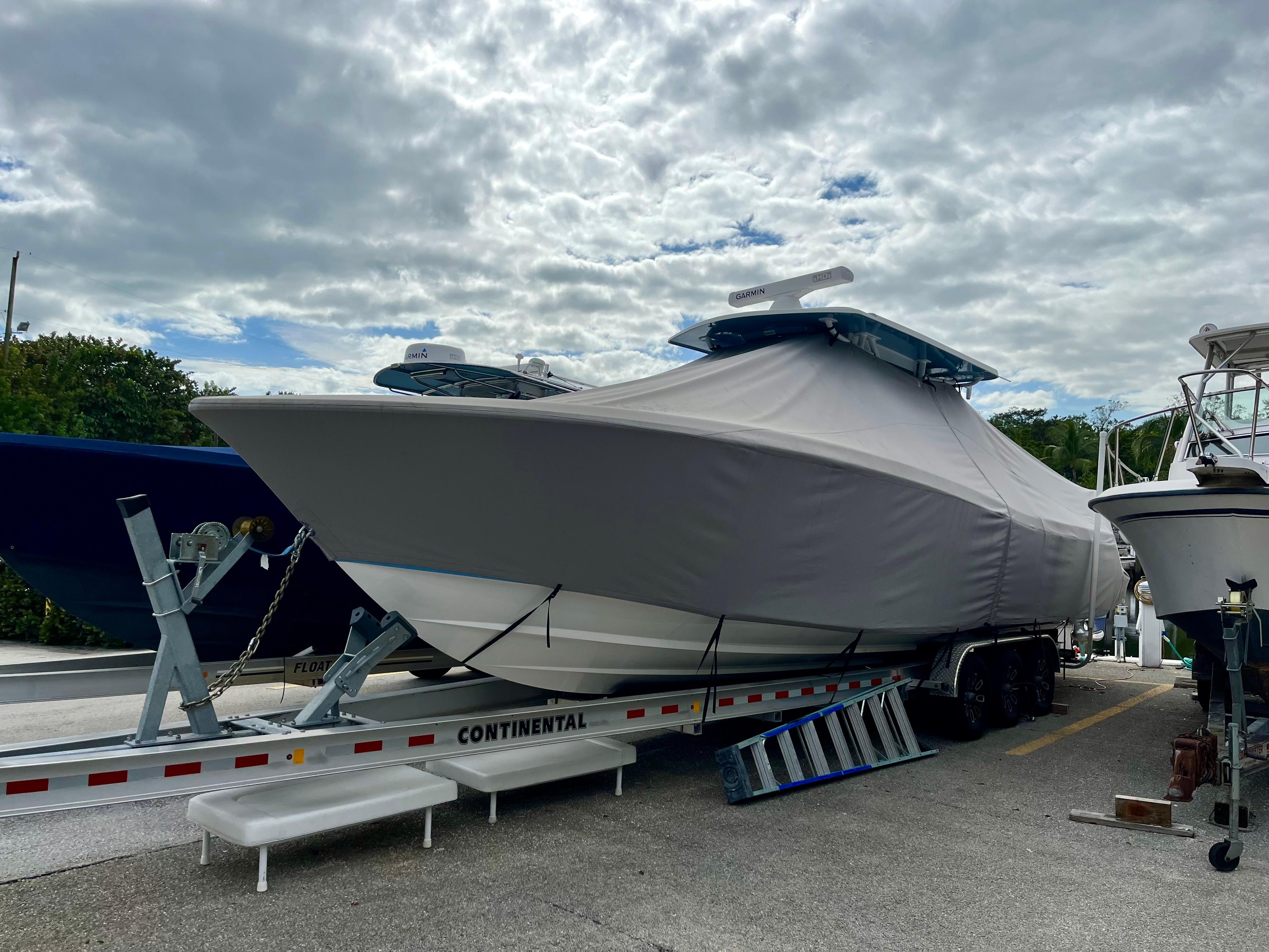 2023 Invincible 36' Open Fisherman boat on trailer, covered and ready for transport.