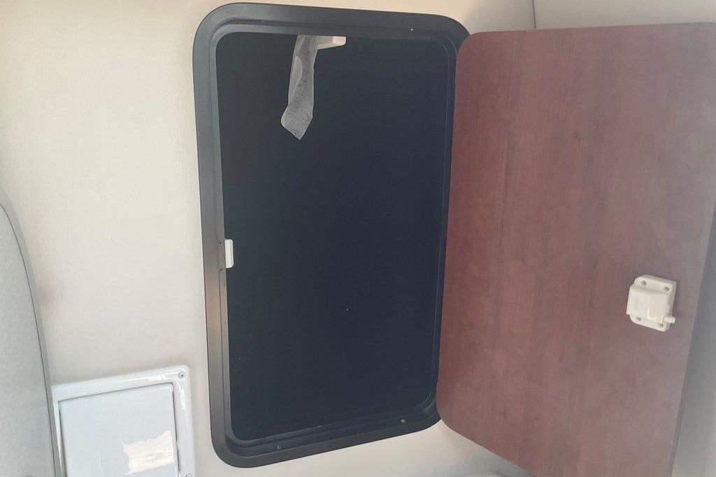 Open storage compartment inside 2015 Crownline 236 SC boat cabin.