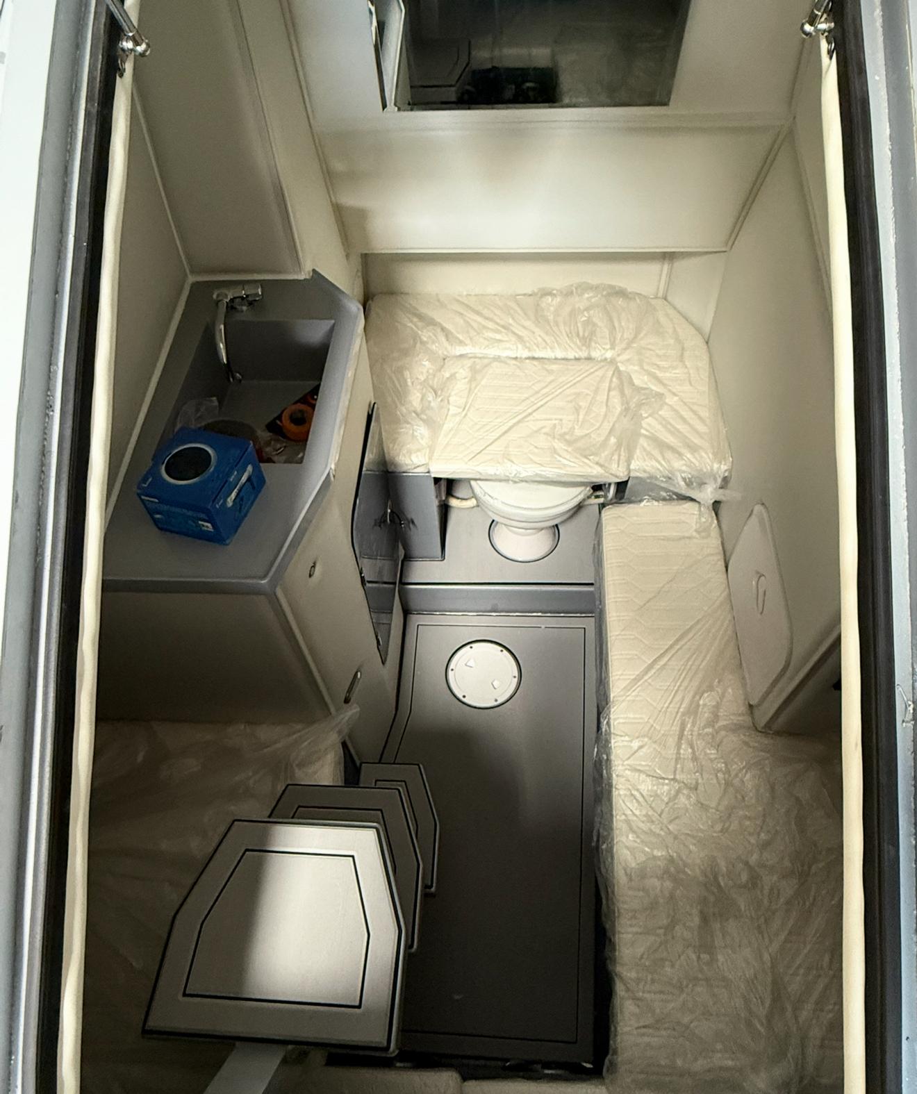 Compact interior of 2026 Novielli Veloche 349 with sink, toilet, and seating.