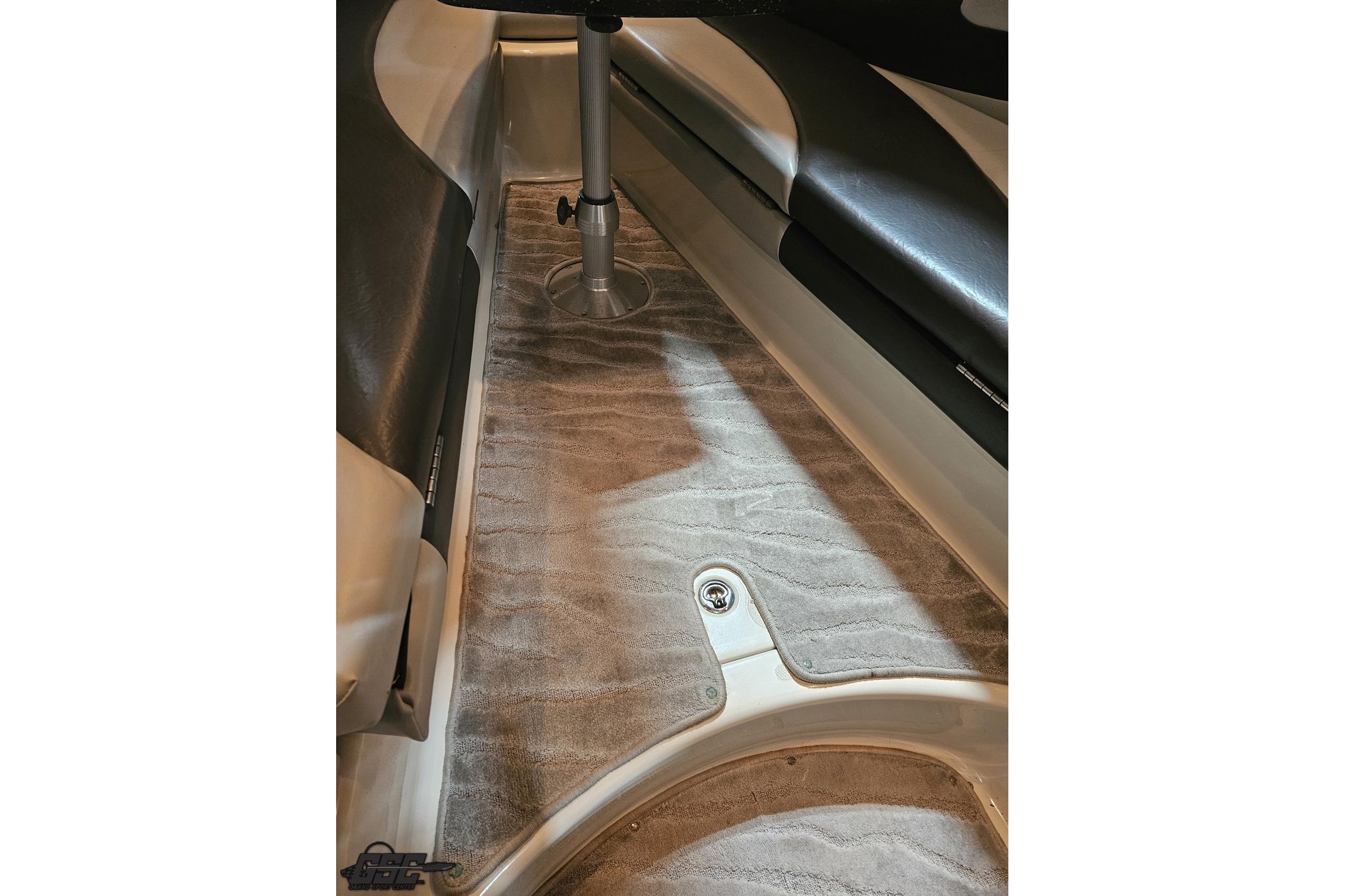 Interior of a 2008 Baja 335 Performance boat, featuring sleek seating and carpeted flooring.