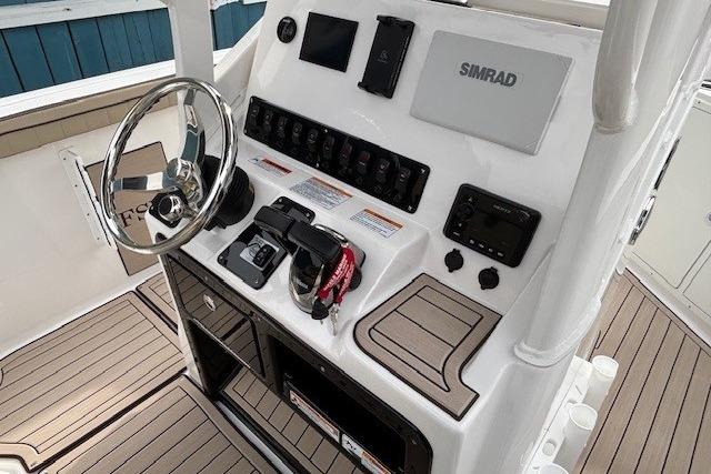 2026 Yamaha Boats 222 FSH Sport E dashboard with Simrad electronics and steering wheel.