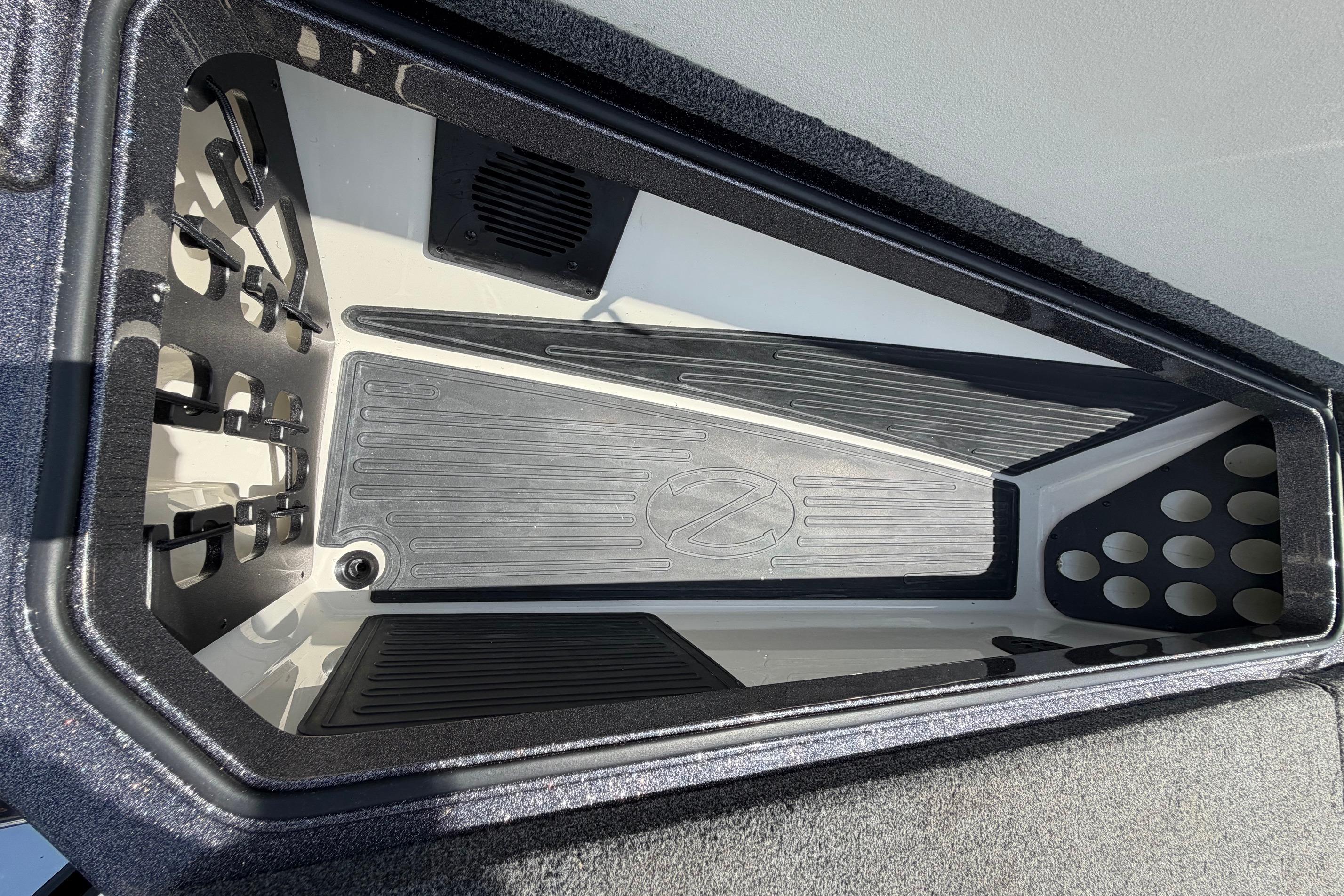 2020 Ranger Z520L boat storage compartment with organized rod holders and non-slip mat.
