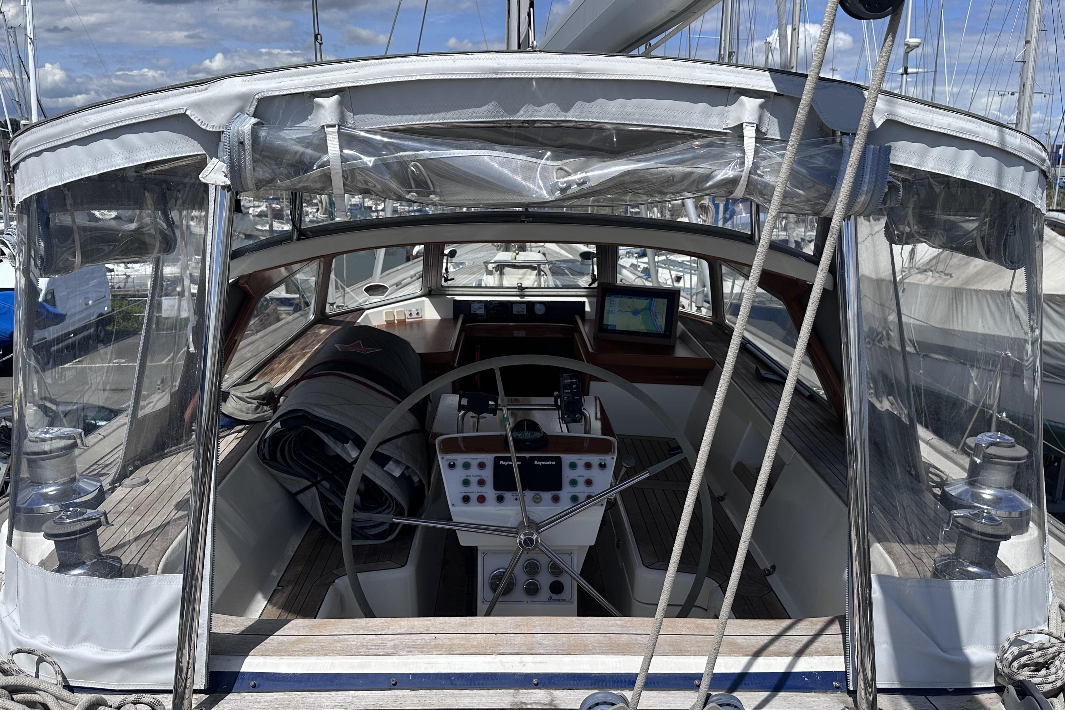 Cockpit of 2008 Hallberg-Rassy 54 sailboat with navigation equipment and steering wheel.