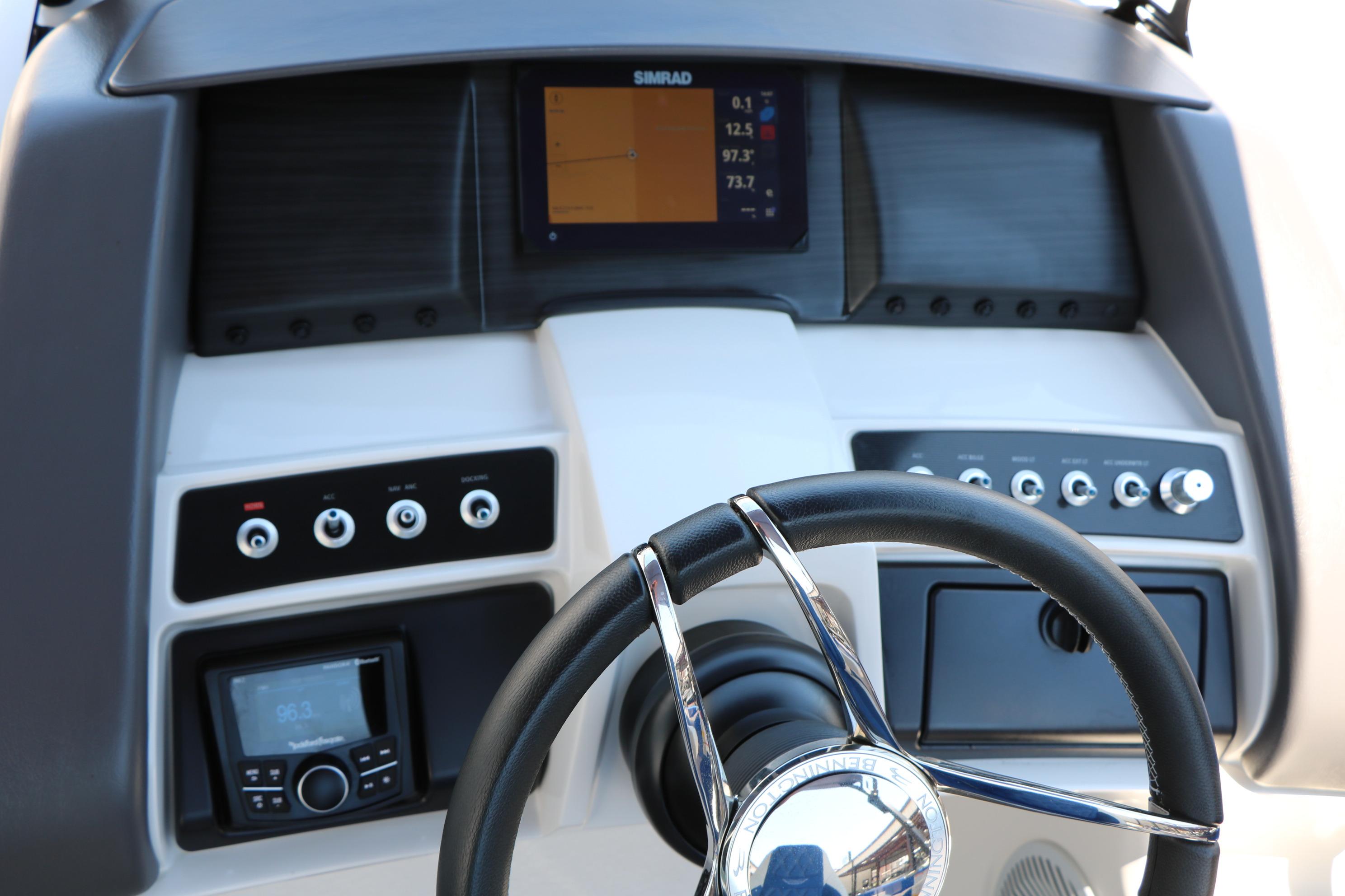 Dashboard of 2024 Bennington 23 RX Swingback boat with steering wheel and control panel.