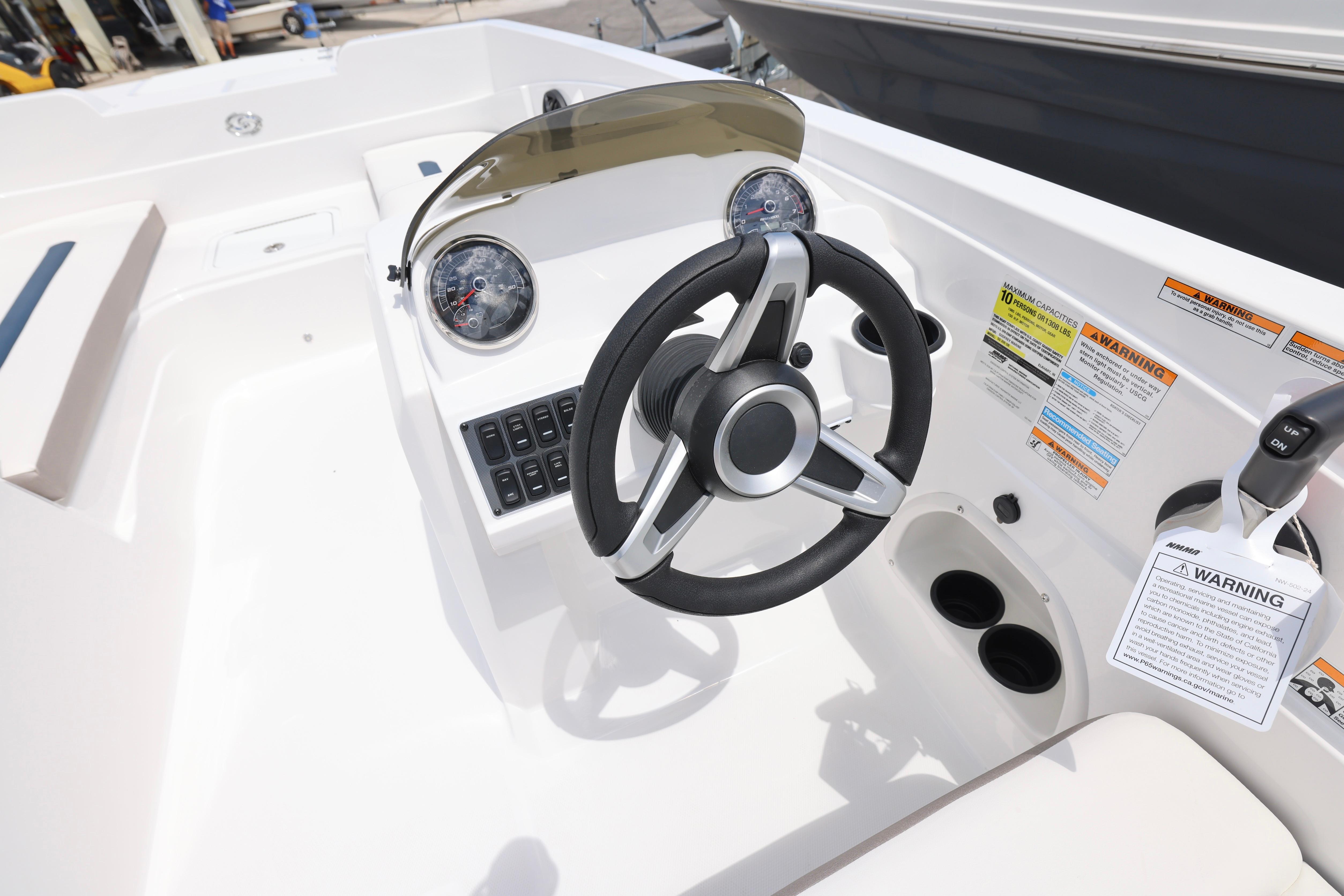 2026 Hurricane SunDeck Sport 205 OB boat dashboard with steering wheel and gauges.