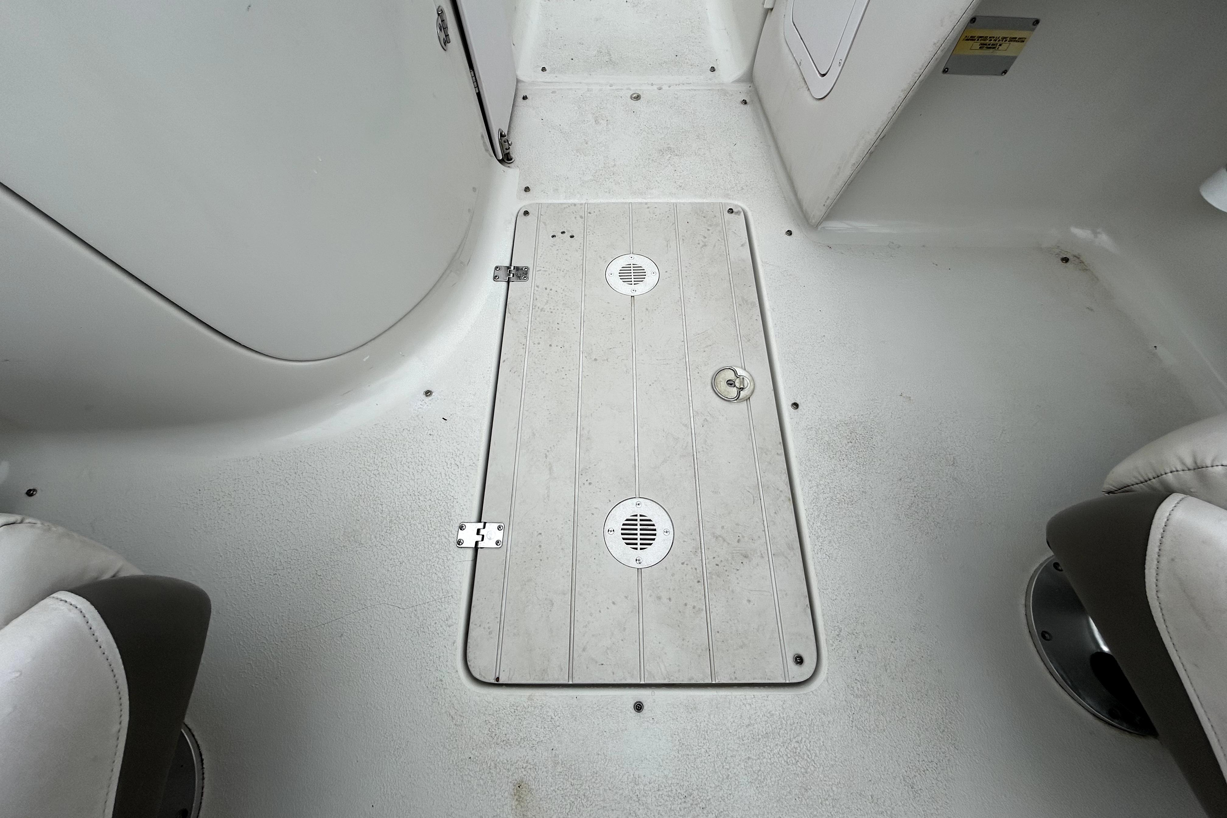 2001 Crownline 239 DB boat interior floor with storage hatch and seating.