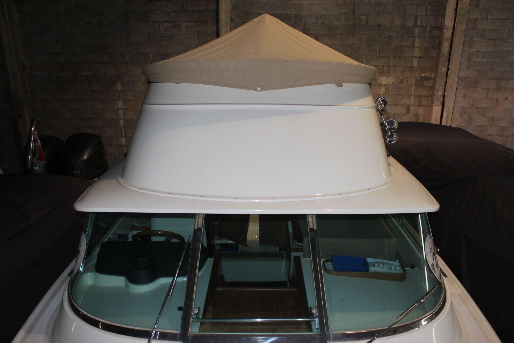 1974 Riva Bertram 25 Sportfisherman boat with covered helm, stored indoors.