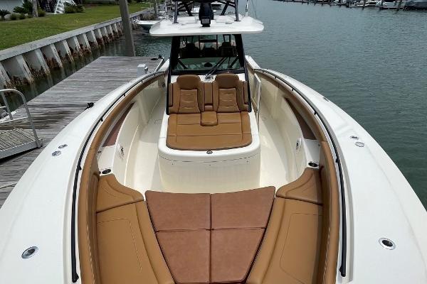 2020 Scout 420 LXF boat with tan seating, docked by the water.