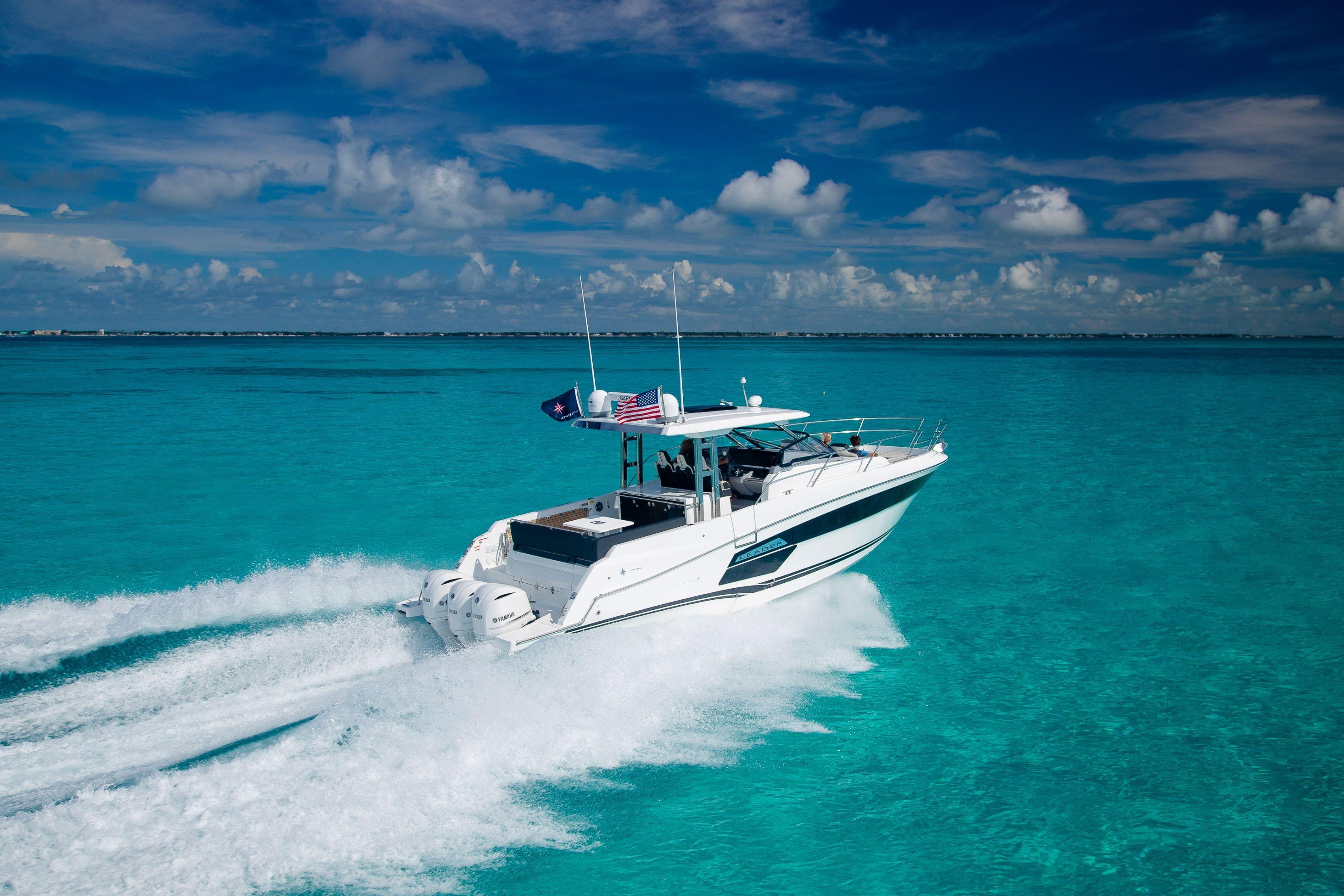 2026 Jeanneau Leader 12.5 WA cruising on clear turquoise waters under a blue sky.