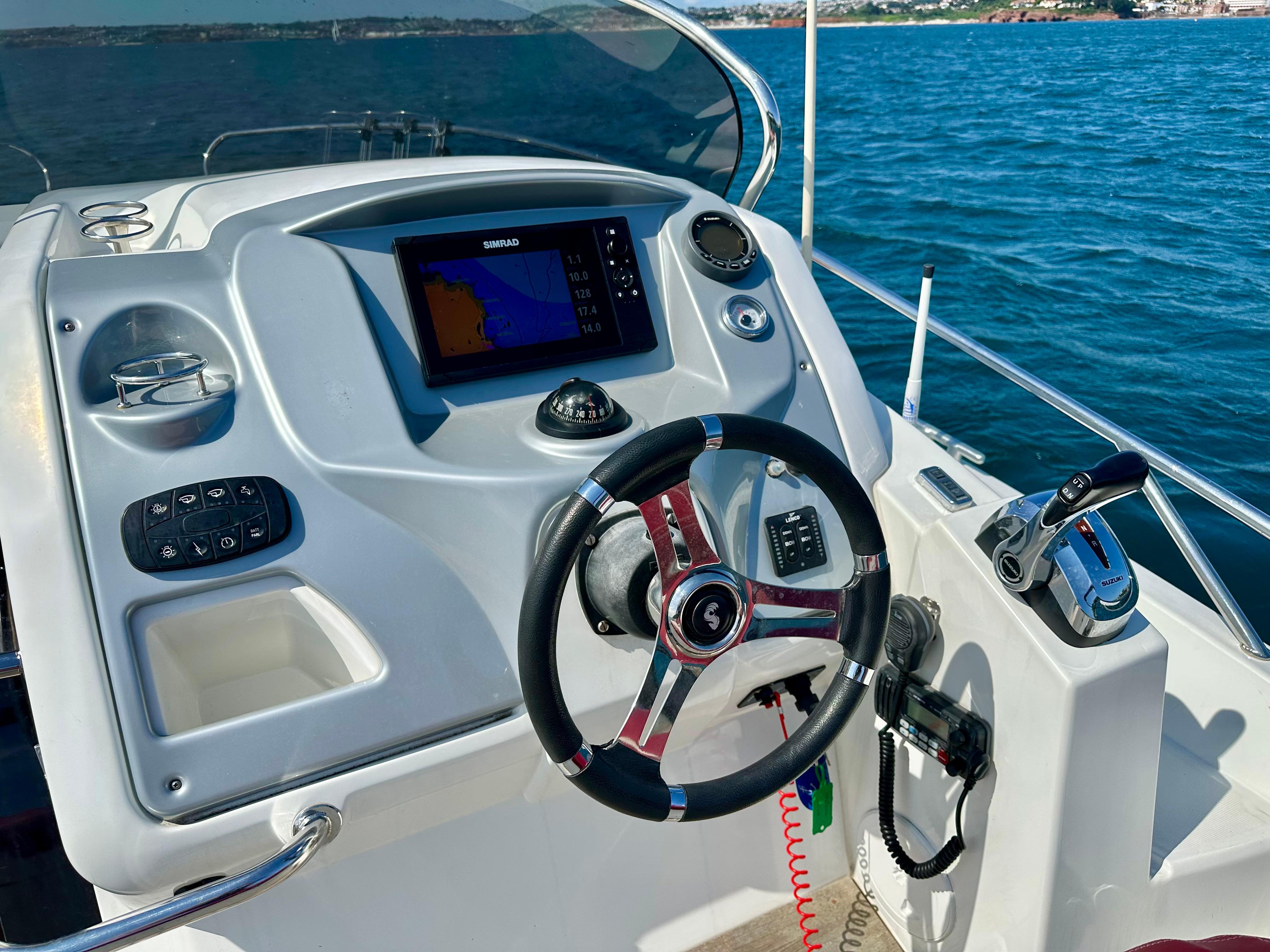 Beneteau Flyer 850 Sundeck 2012 helm with navigation system on open water.