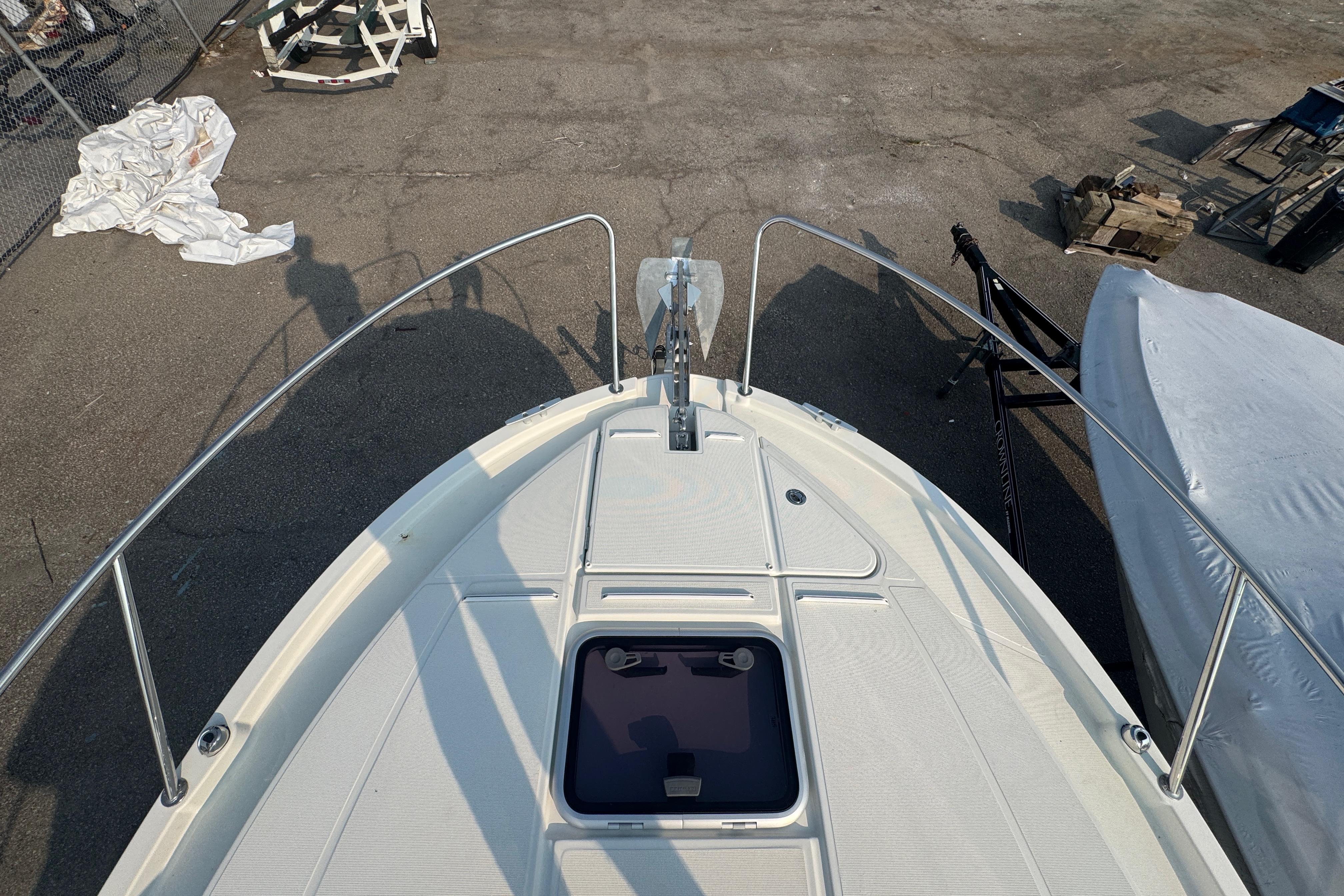Bow view of 2019 Beneteau Antares 23 boat, docked with visible anchor and deck.