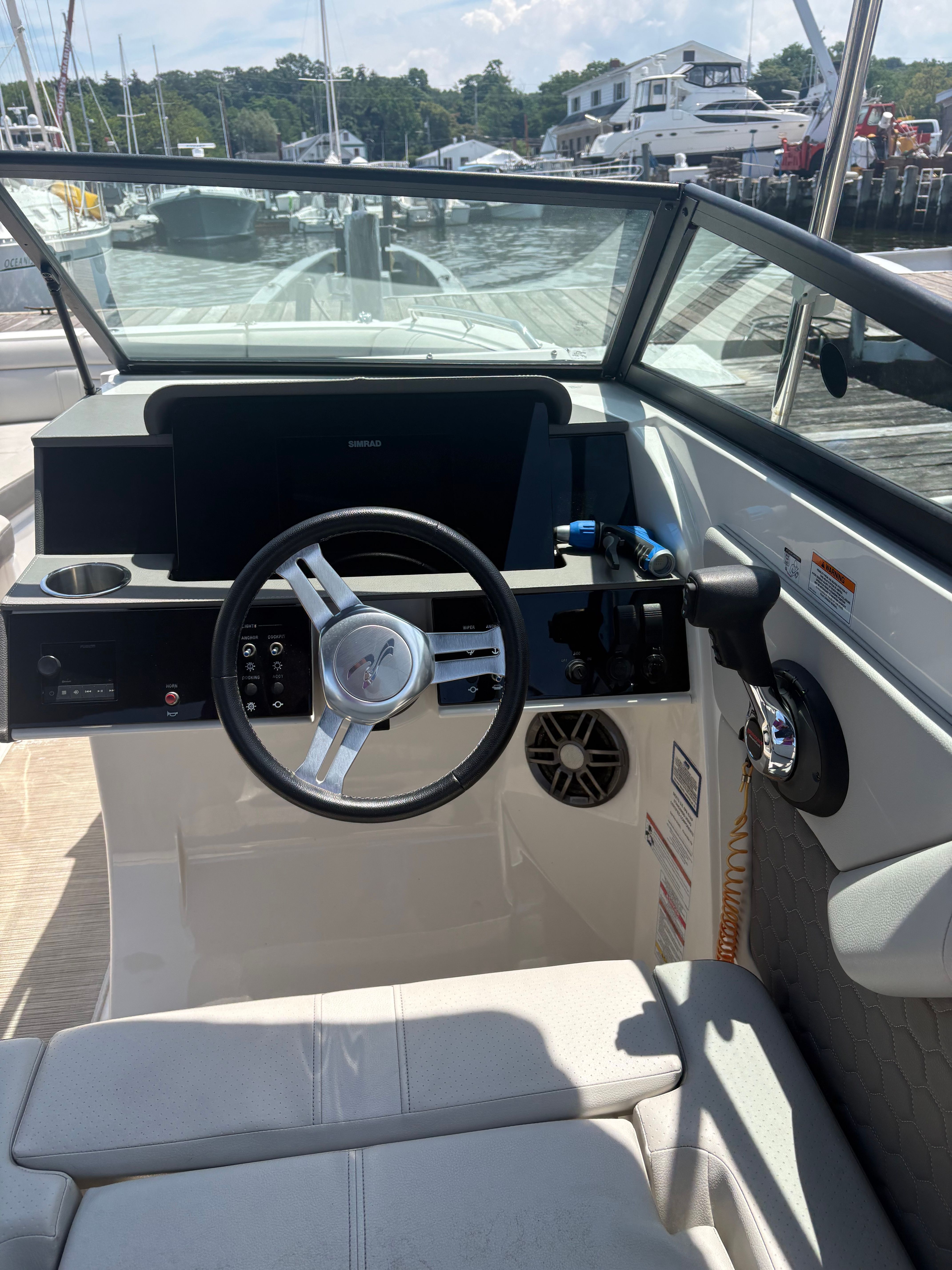 The image shows the cockpit of a 2022 Sea Ray SDX 270 Outboard with a modern helm.
