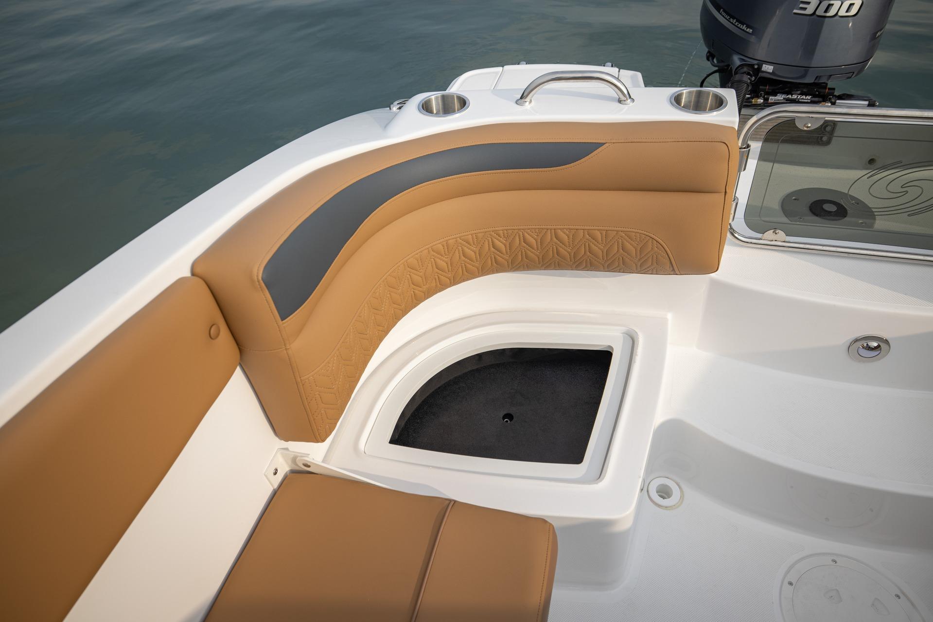 2026 Hurricane SunDeck 2690 OB boat interior with tan seating and storage compartment.