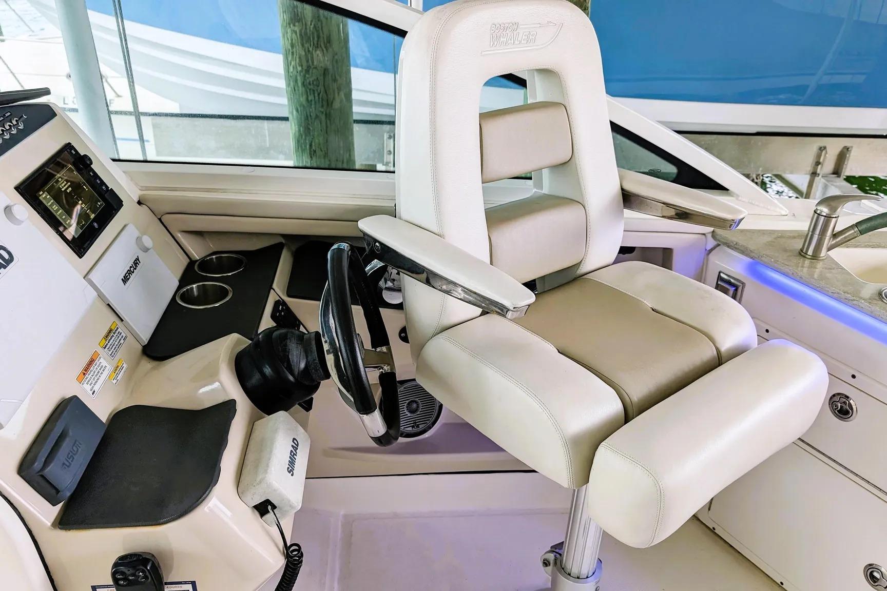 Captain's seat and helm of 2017 Boston Whaler 320 Vantage boat.