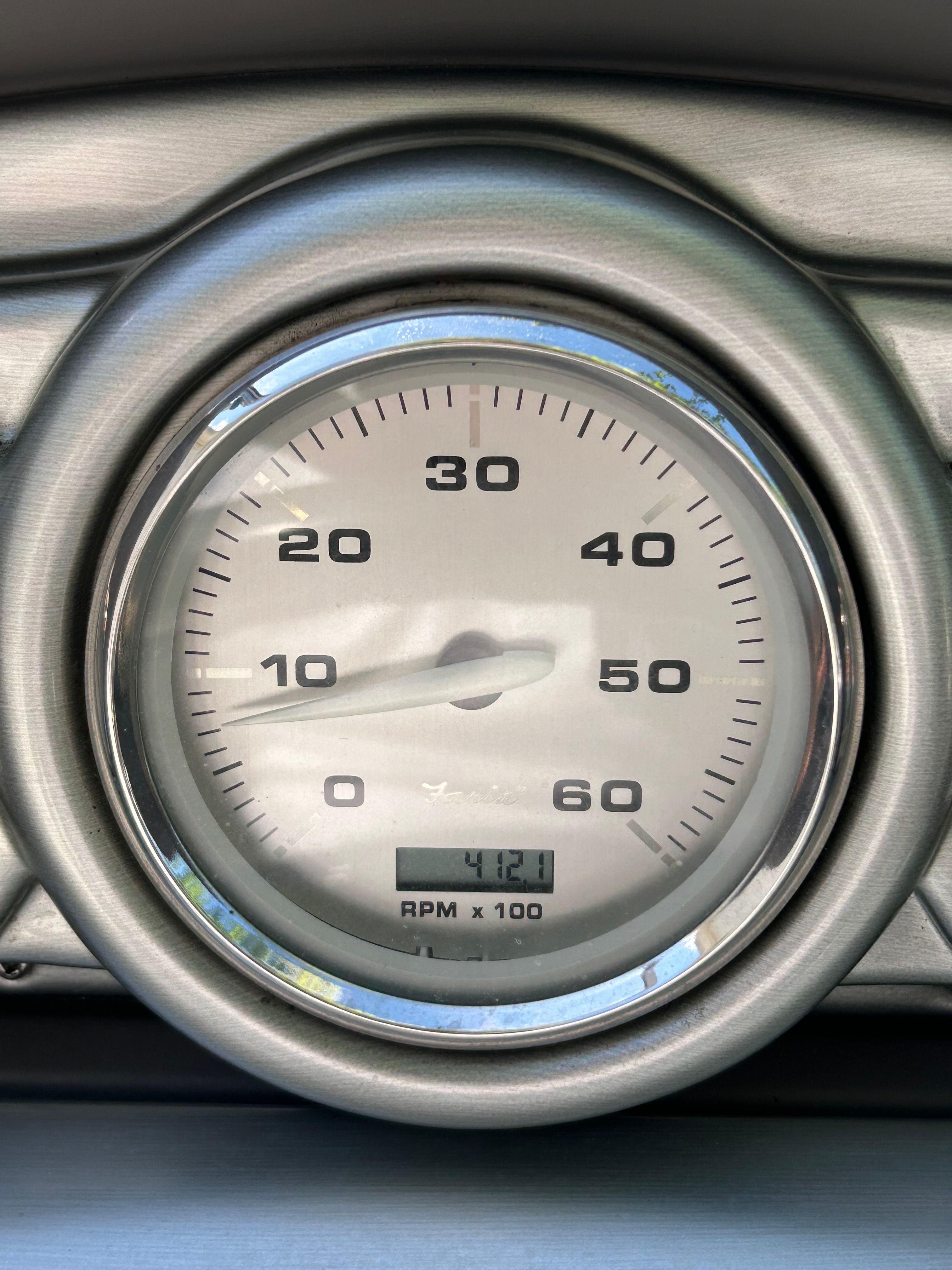 Close-up of a tachometer showing 4120 RPM.