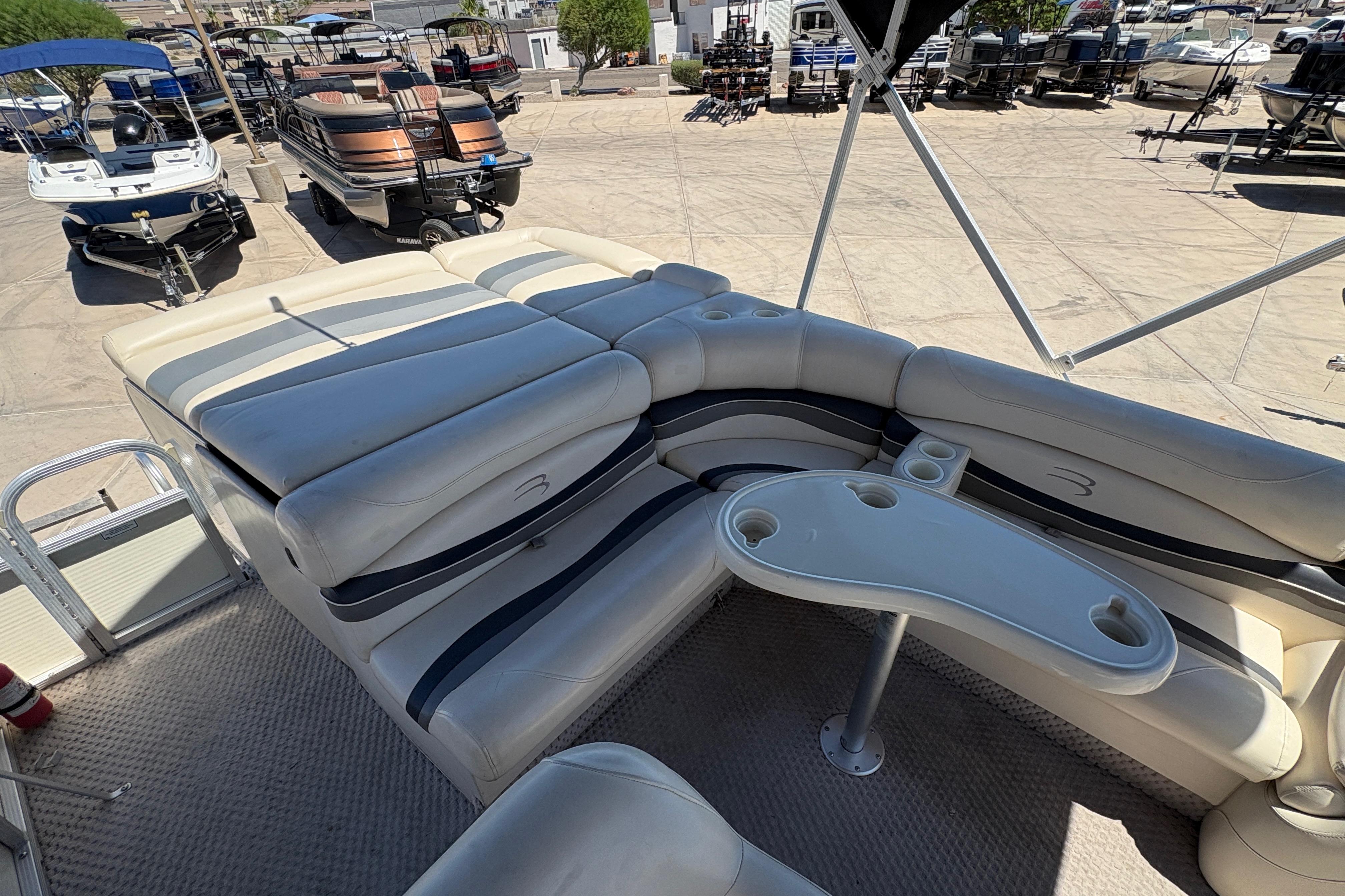 2005 Bennington 2575RFS I/O boat interior with cushioned seating and cup holders.