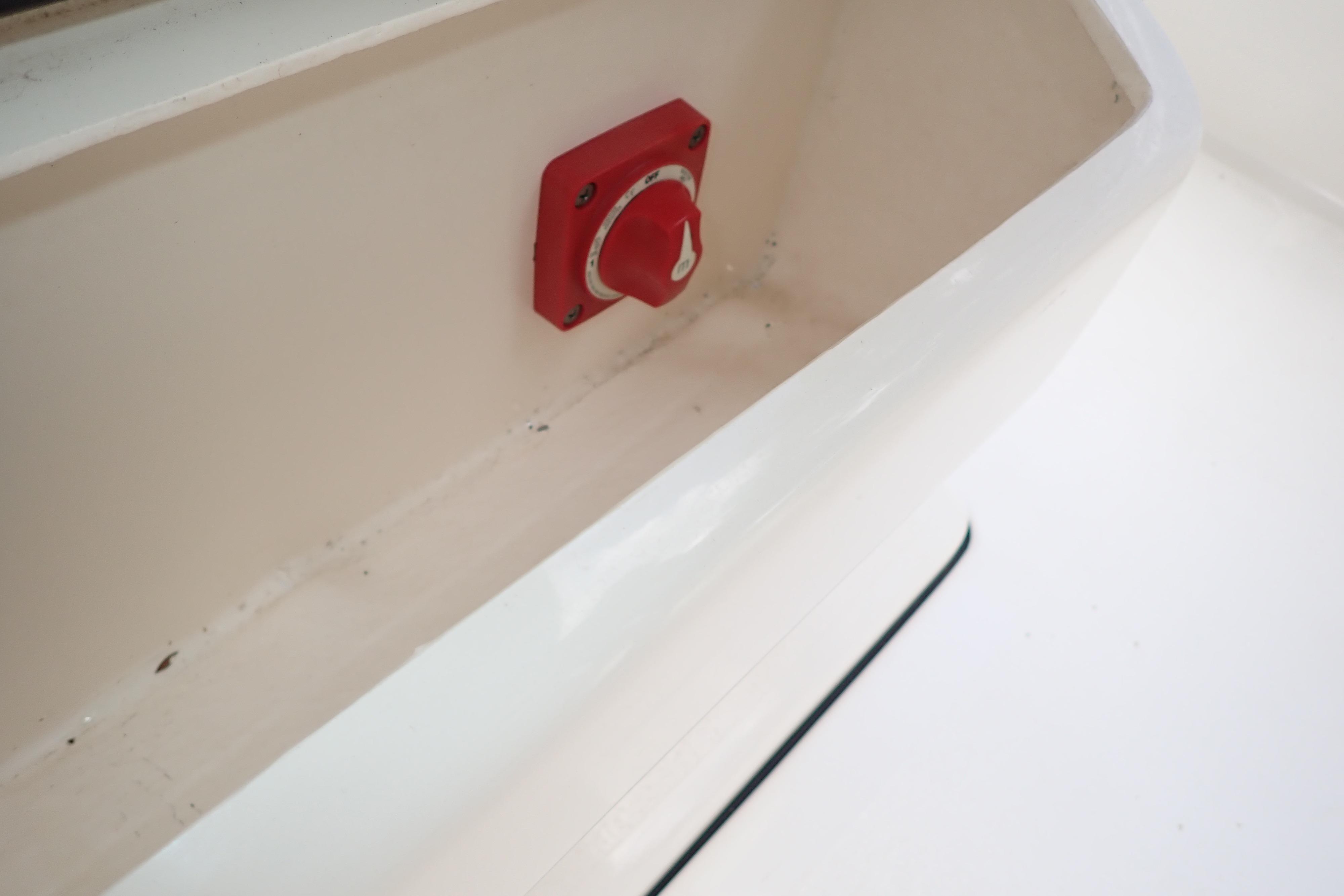 Red switch inside a 2019 Key West 263 FS boat compartment.