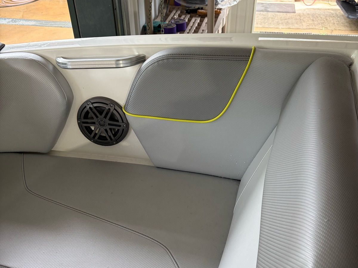 Interior of a 2017 MasterCraft NXT22 boat with gray upholstery and speaker.