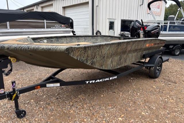 2026 Tracker Grizzly 1756 T Marsh boat on trailer, camo design, parked outdoors.