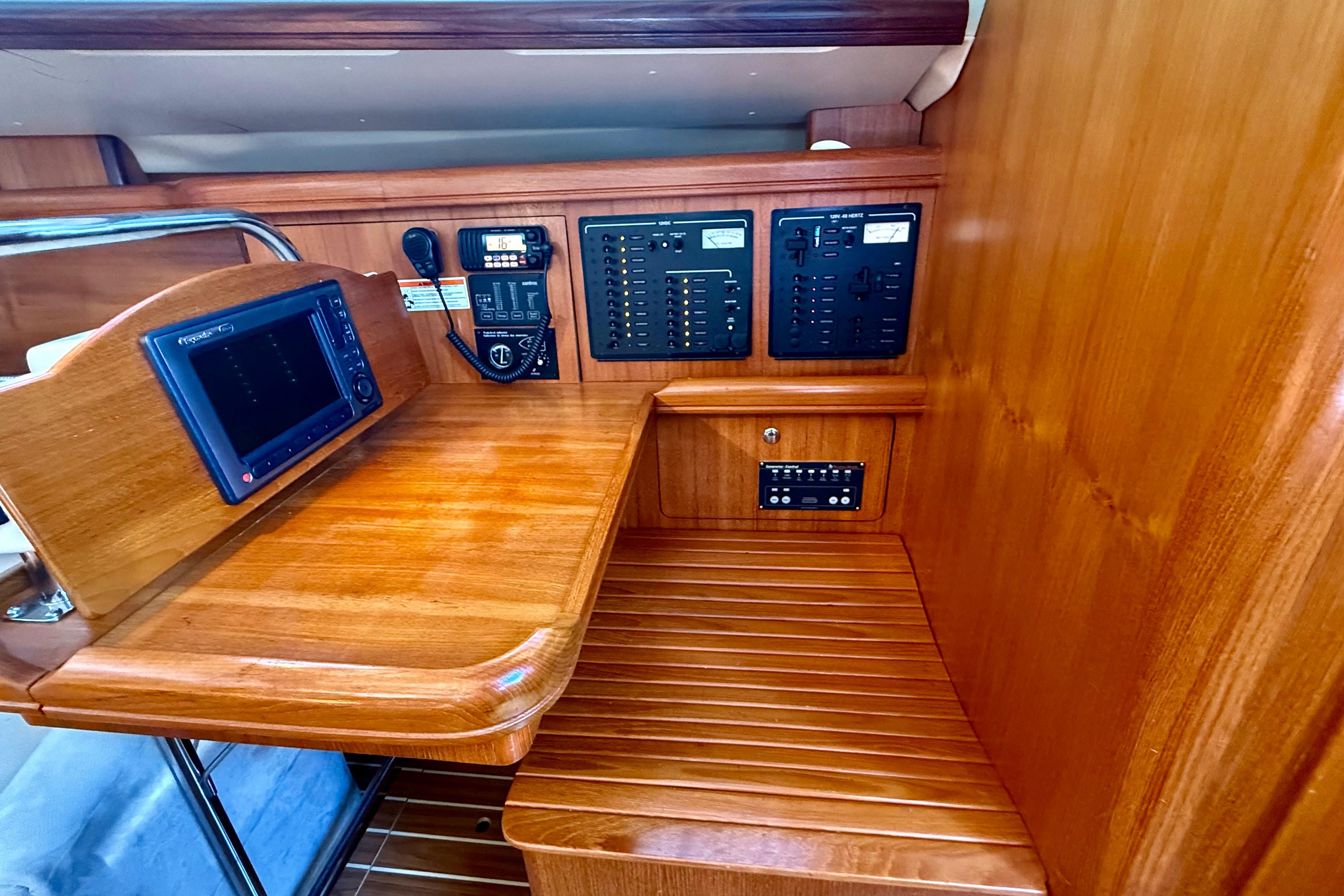 2007 Hunter 41 Deck Salon navigation station with control panels and wood finish.