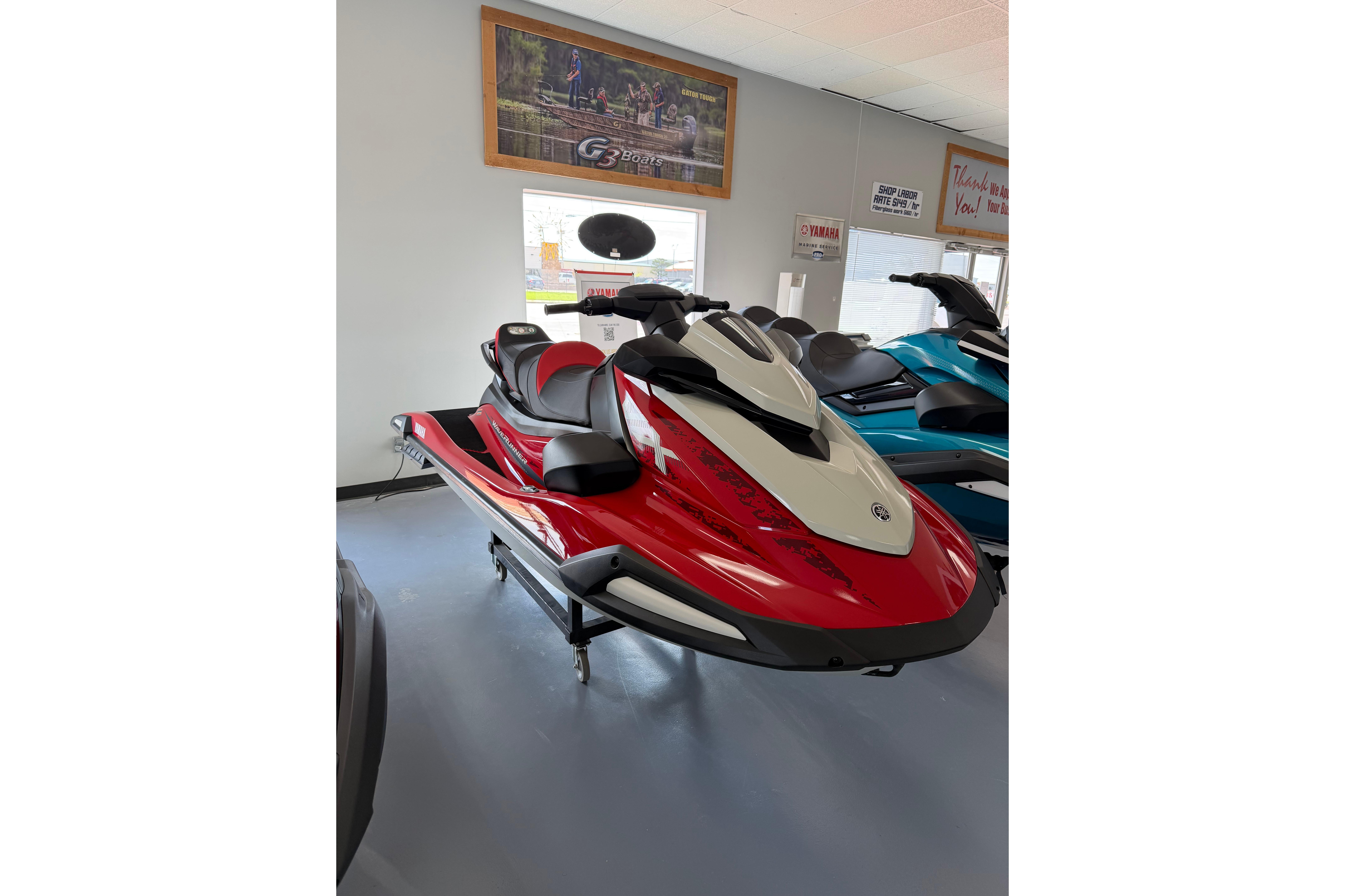 2026 Yamaha WaveRunner VX Cruiser in showroom, red and white design, sleek and modern.