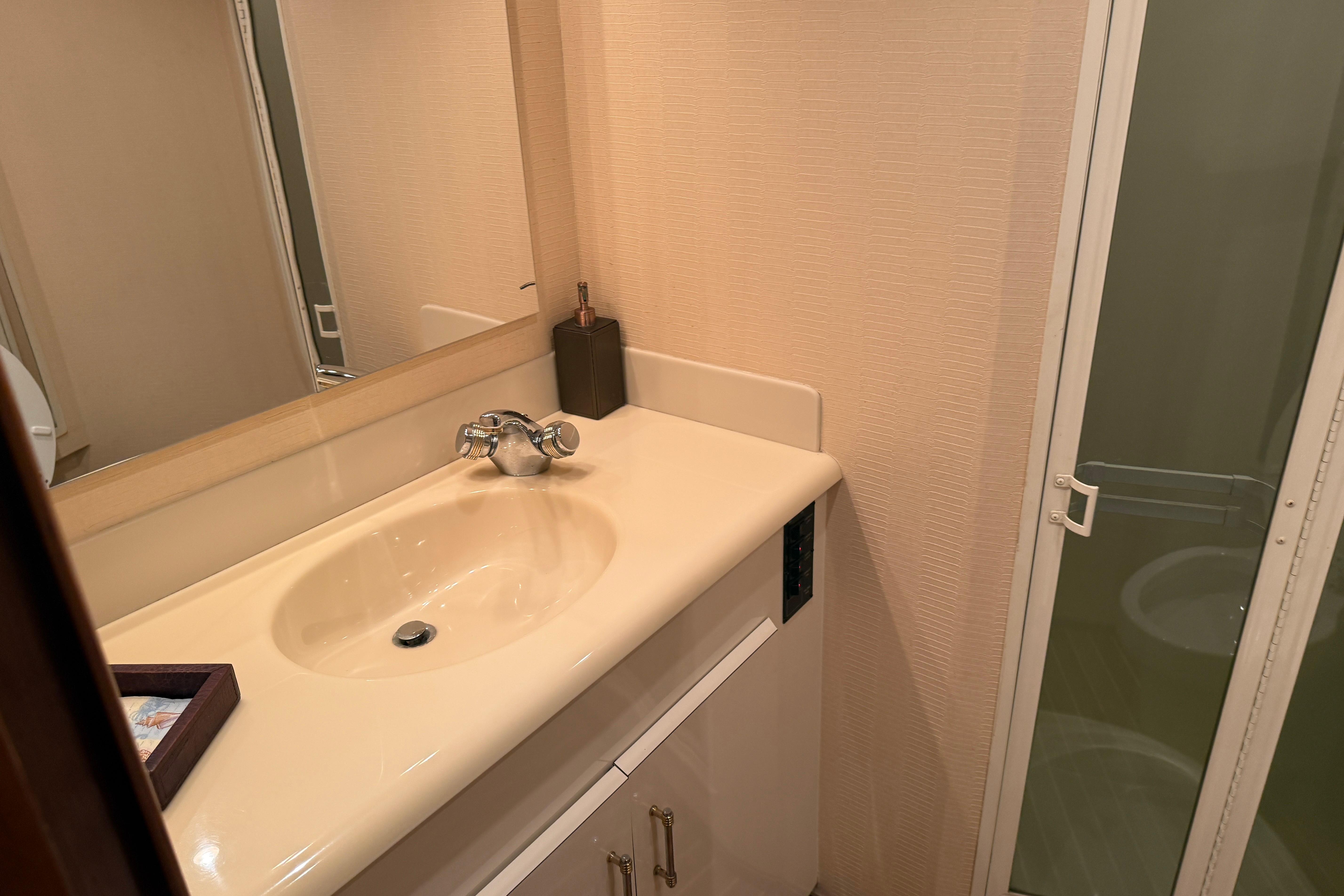 Bathroom interior of 2000 Viking 55 Convertible yacht with sink and shower.