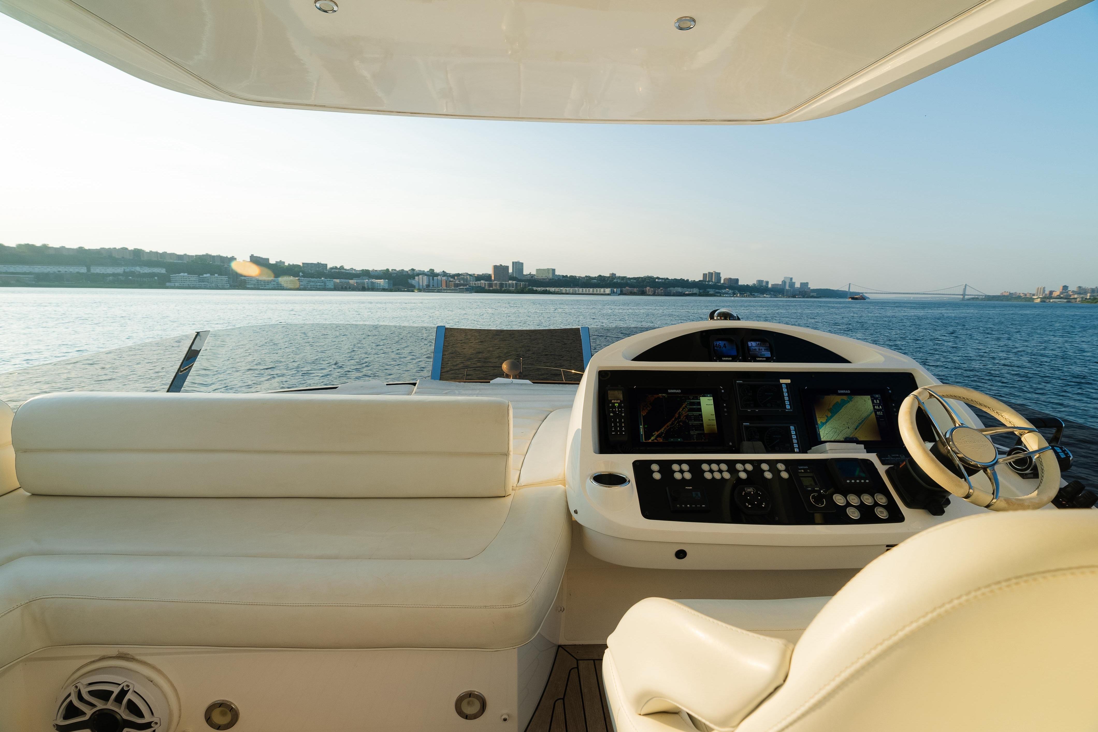 Luxurious 2016 Sunseeker Manhattan 65 yacht helm with scenic ocean view.