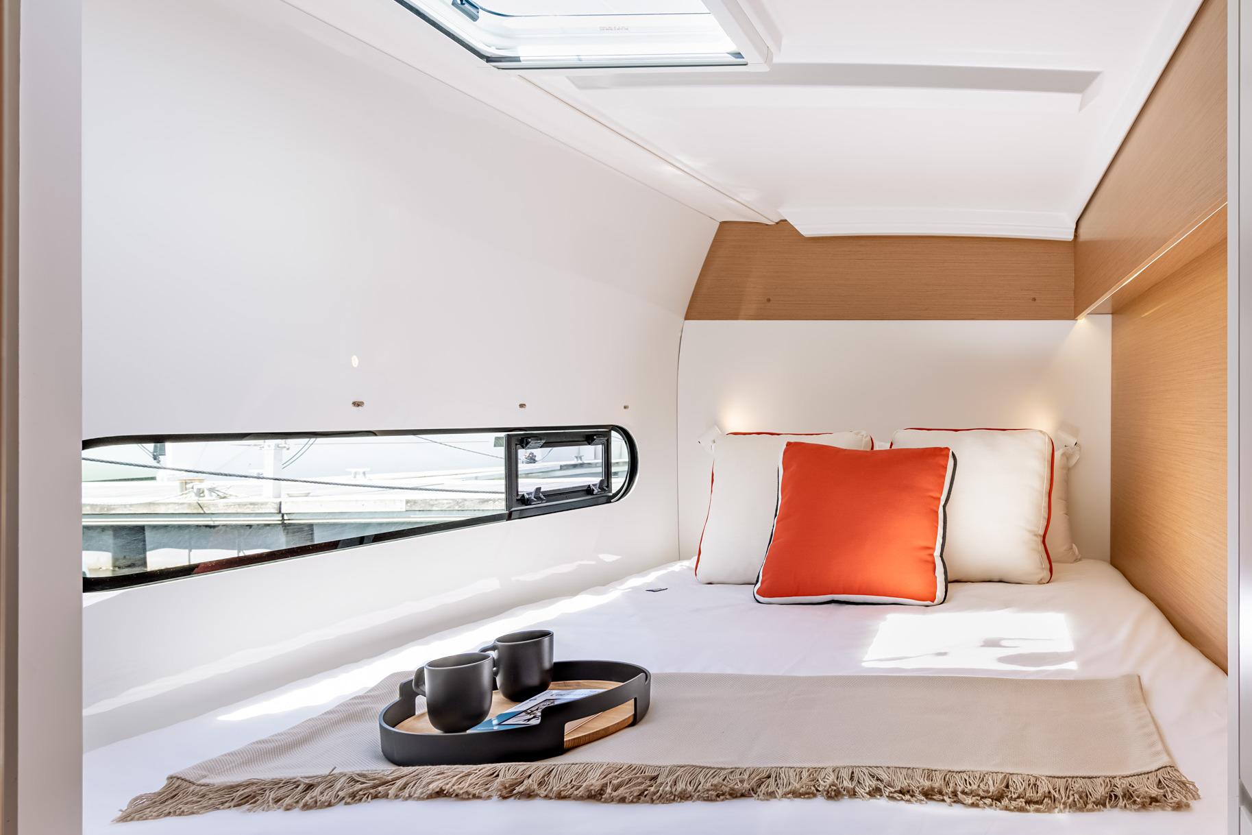 Luxurious cabin interior of 2026 Excess 11 yacht with cozy bed and stylish decor.