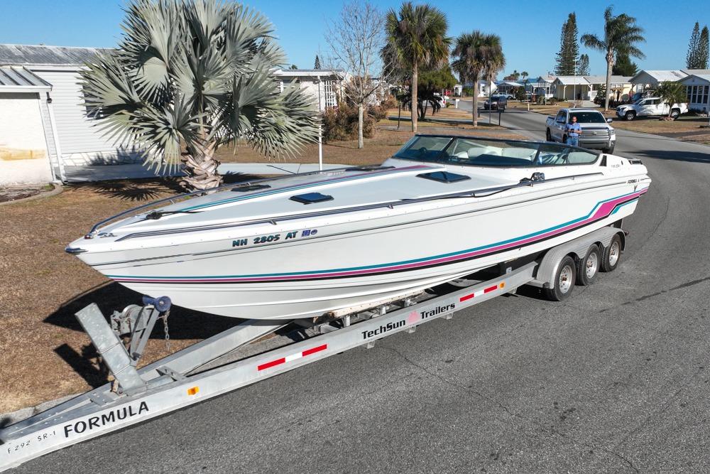 1989 Formula 292 SR-1 speedboat on trailer, parked in a residential area.