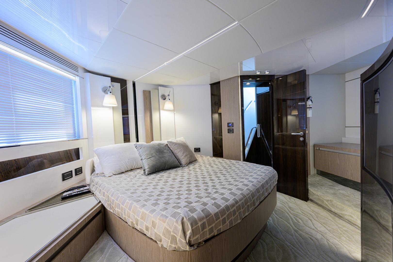 Luxurious bedroom interior of 2019 Azimut S7 yacht with modern design and cozy lighting.