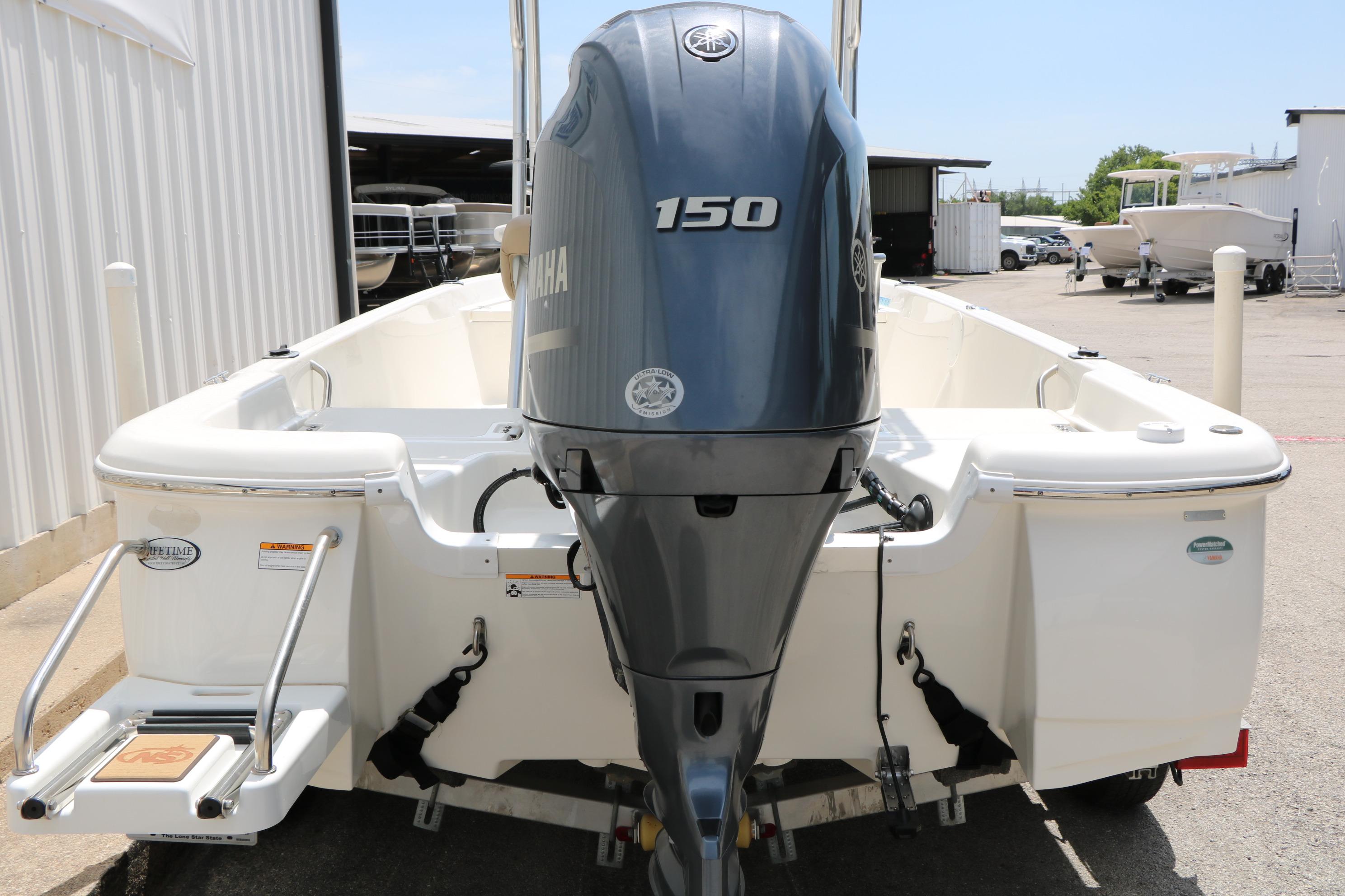 2020 NauticStar 2140 Sport boat with Yamaha 150 engine, docked outdoors.