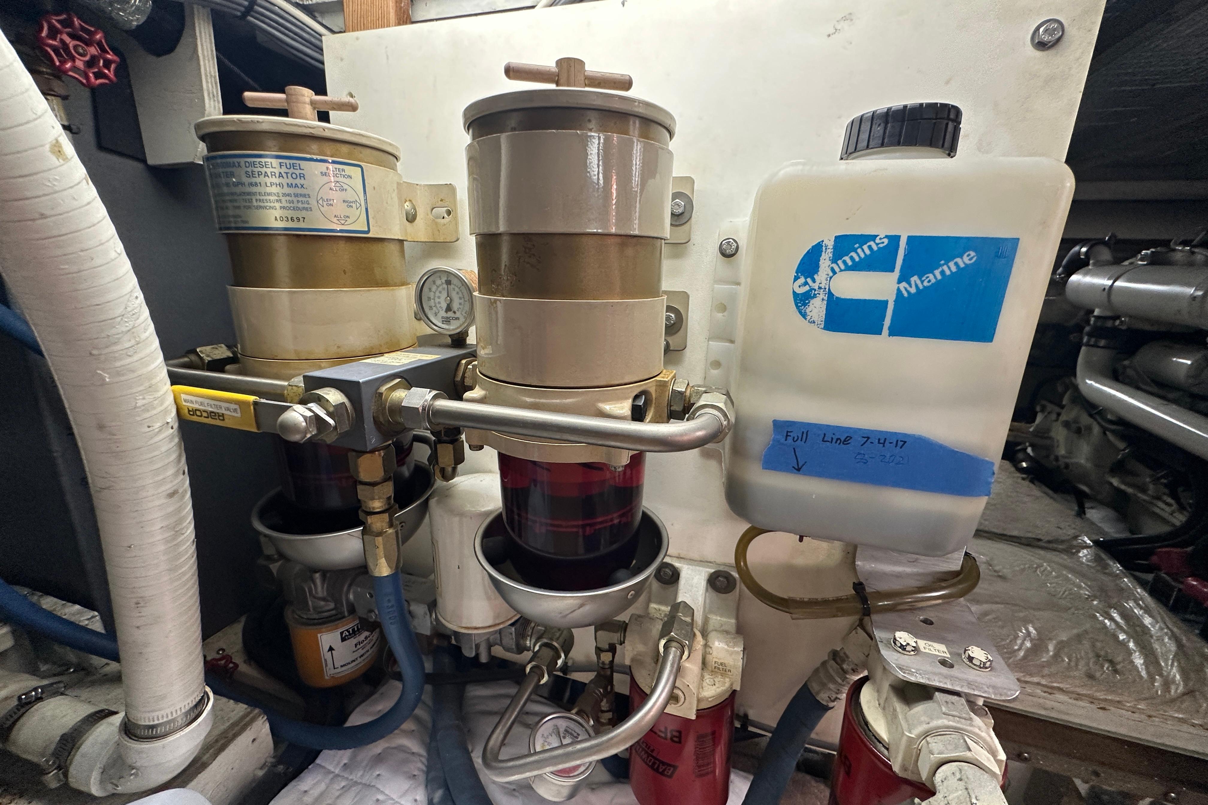 Engine room of 1972 Tollycraft 42 Tri-Cabin with fuel filters and Cummins Marine container.
