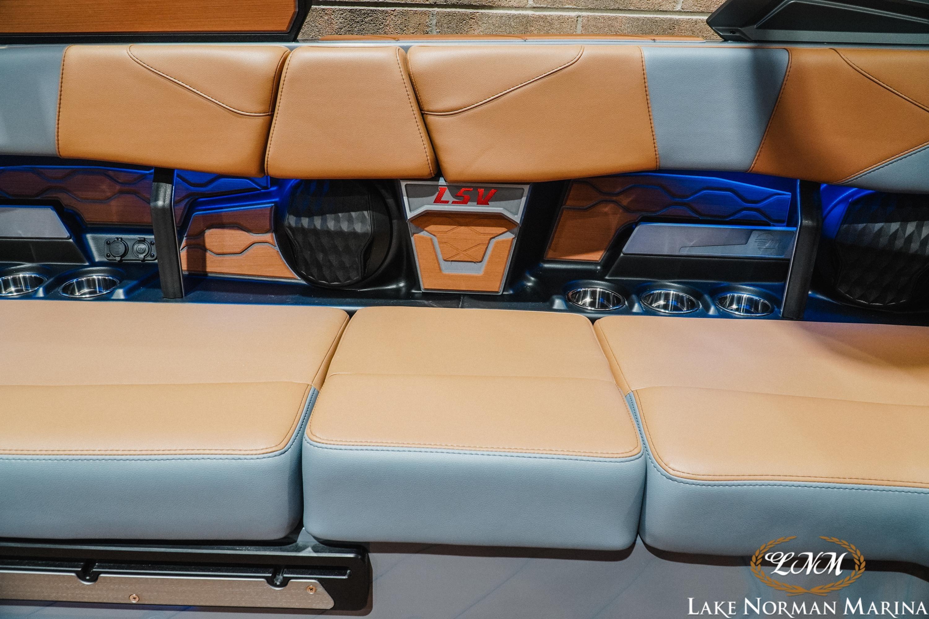 2026 Malibu Wakesetter 23 LSV interior with tan and gray seating, cup holders, and LSV logo.