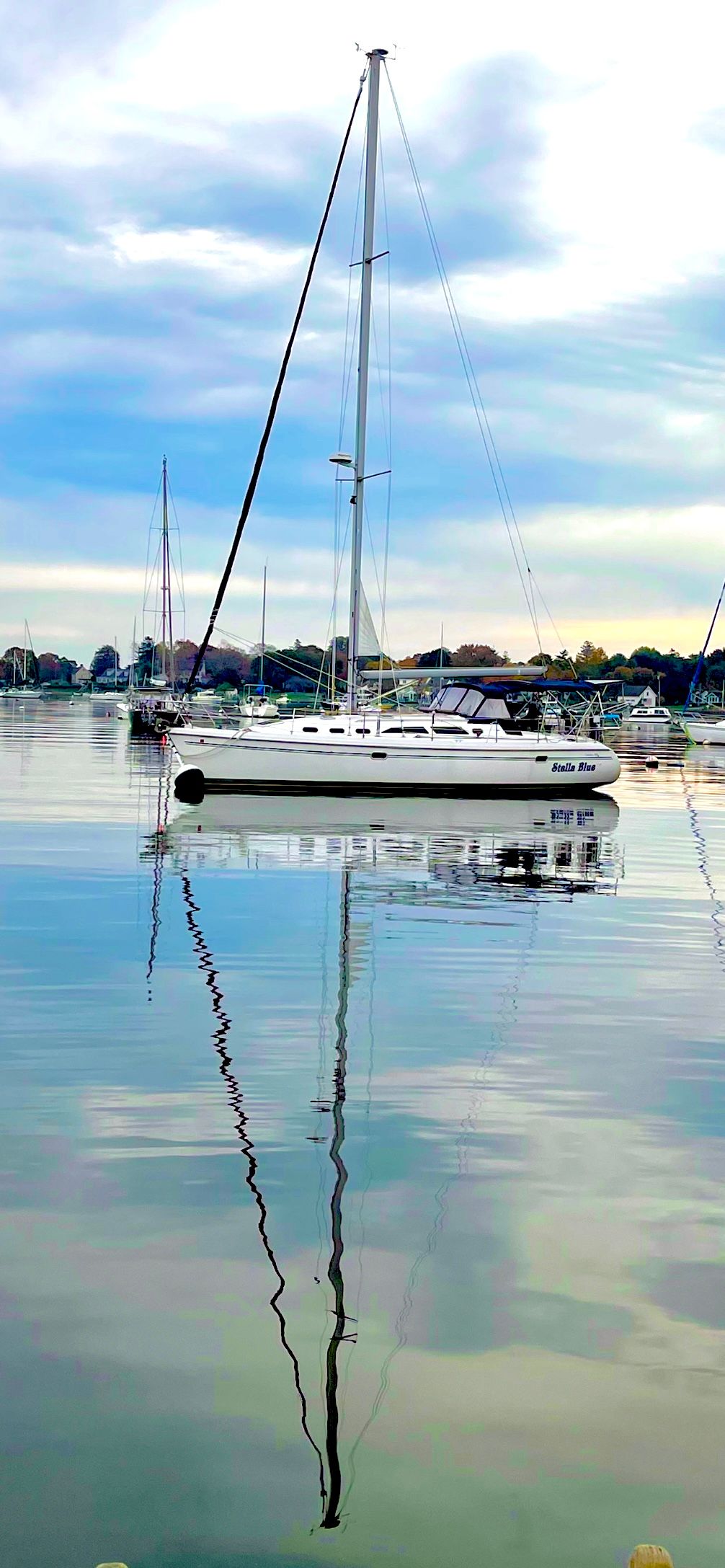 2003 Catalina 380 sailboat on calm water under cloudy sky.