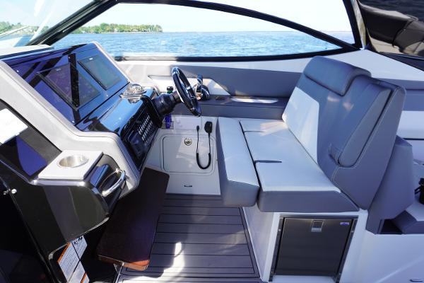 2020 Cruisers Yachts 38 GLS OB interior with modern helm and seating, overlooking the water.