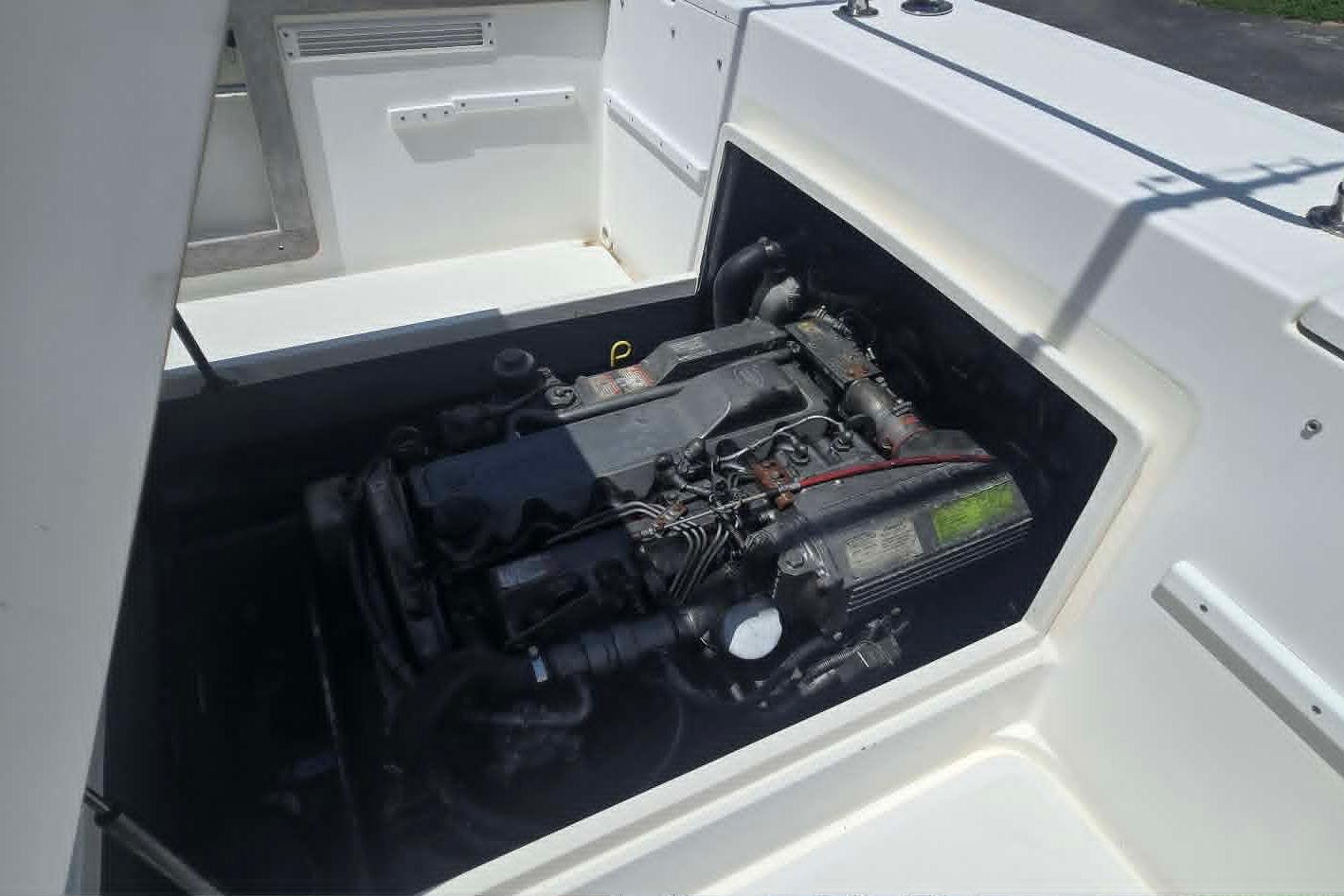 Engine compartment of a 2003 True World Marine 286 boat, showcasing the engine details.