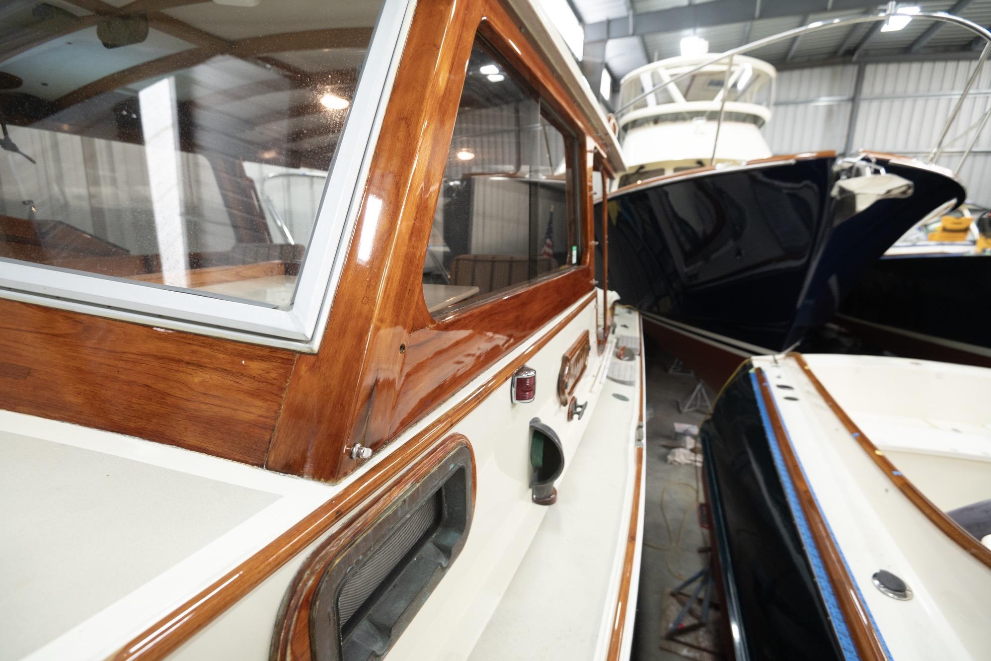 1986 Dyer Hardtop boat in storage, showcasing polished wood and sleek design.