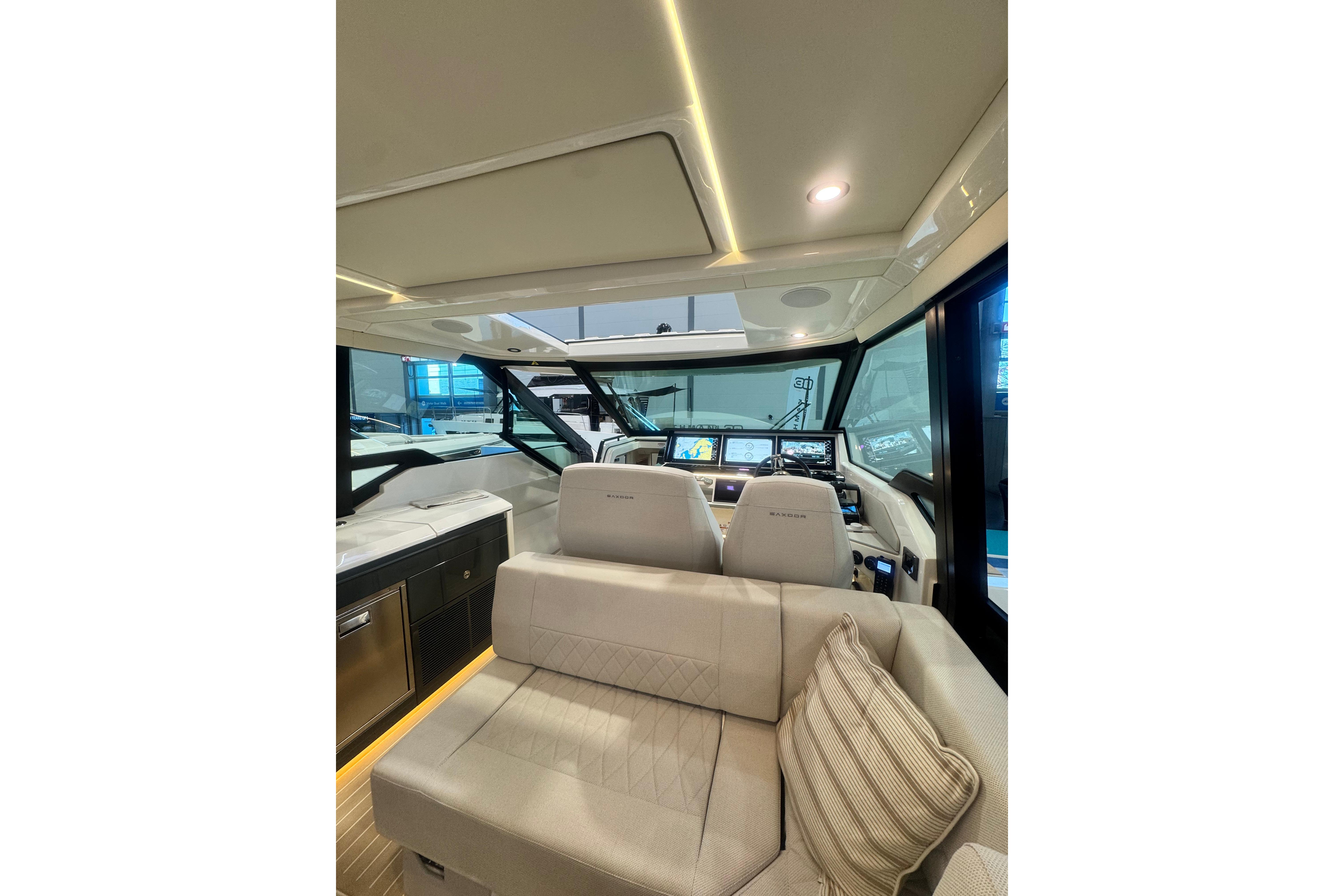 Luxurious interior of 2026 Saxdor 400 GTC yacht with modern dashboard and seating.