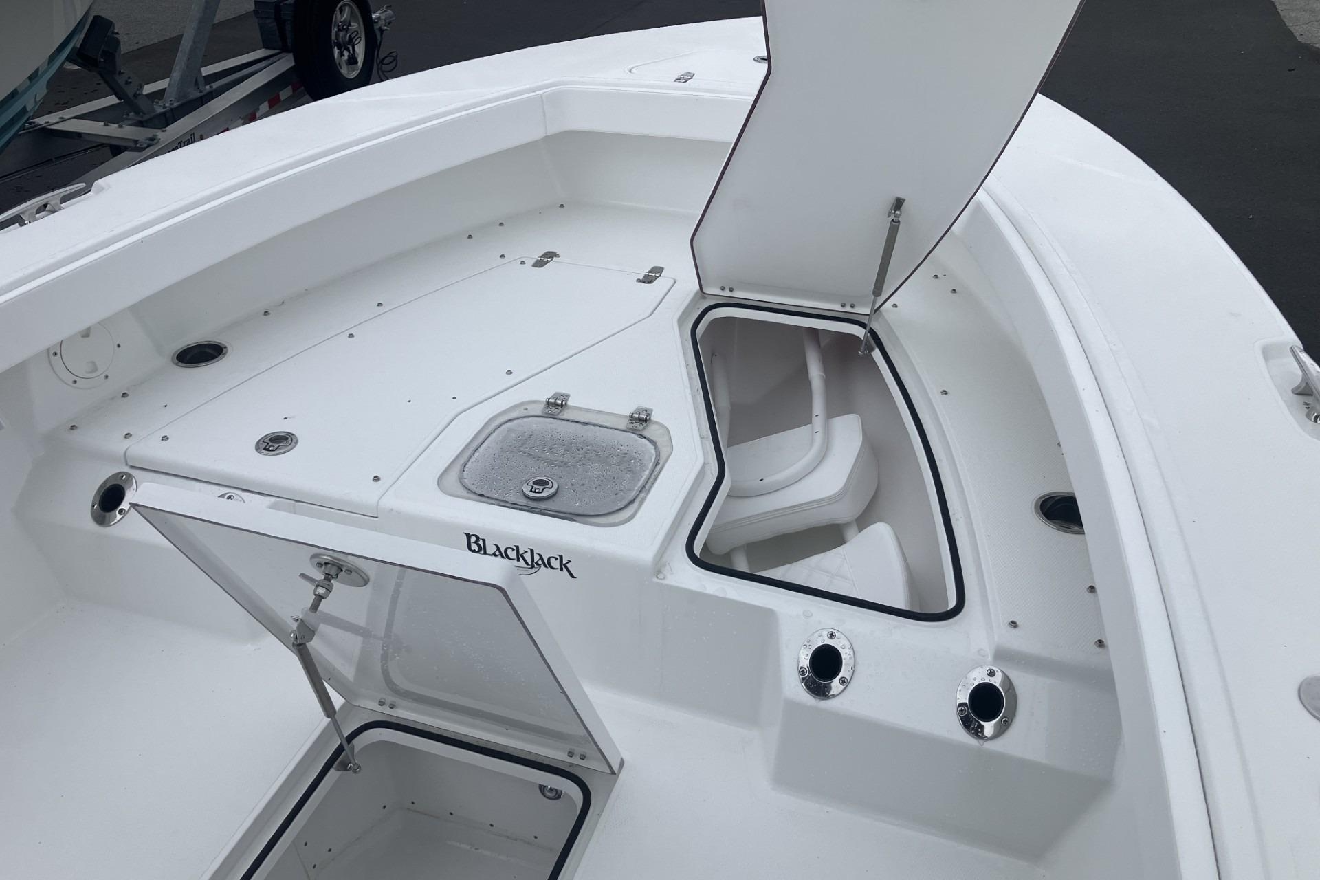 2026 BlackJack 256 Coastal boat interior with open storage compartments and sleek white design.