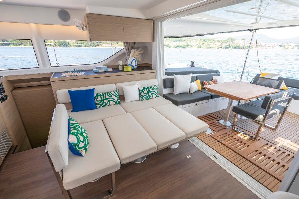 Luxurious interior of 2025 Lagoon 43 yacht with modern seating and dining area.