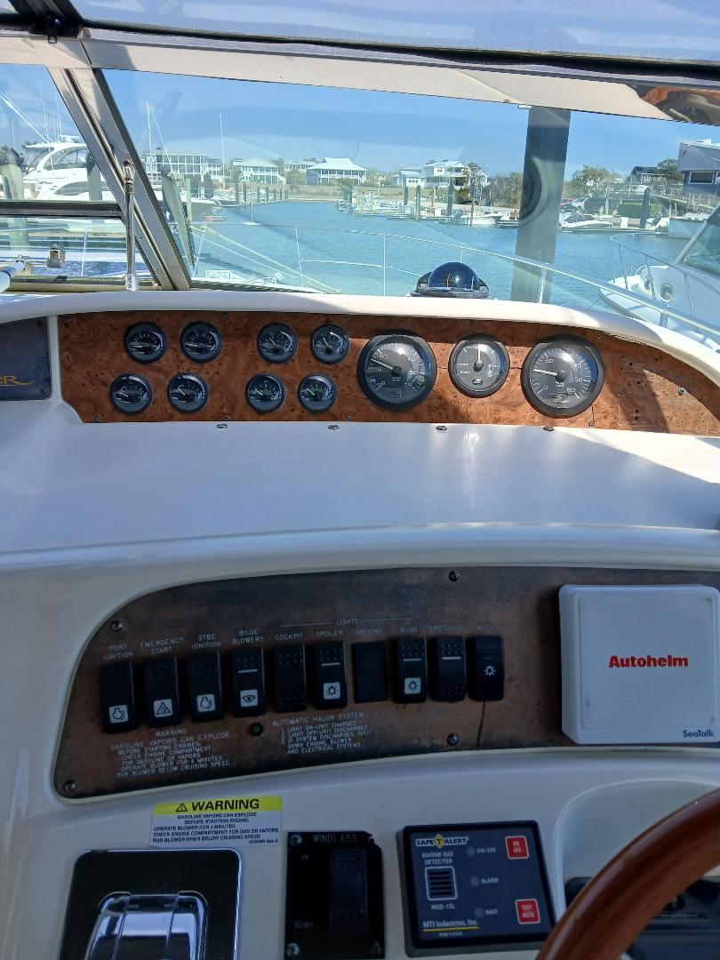 Control panel of a 1997 Sea Ray 370 Sundancer boat, docked at a marina.