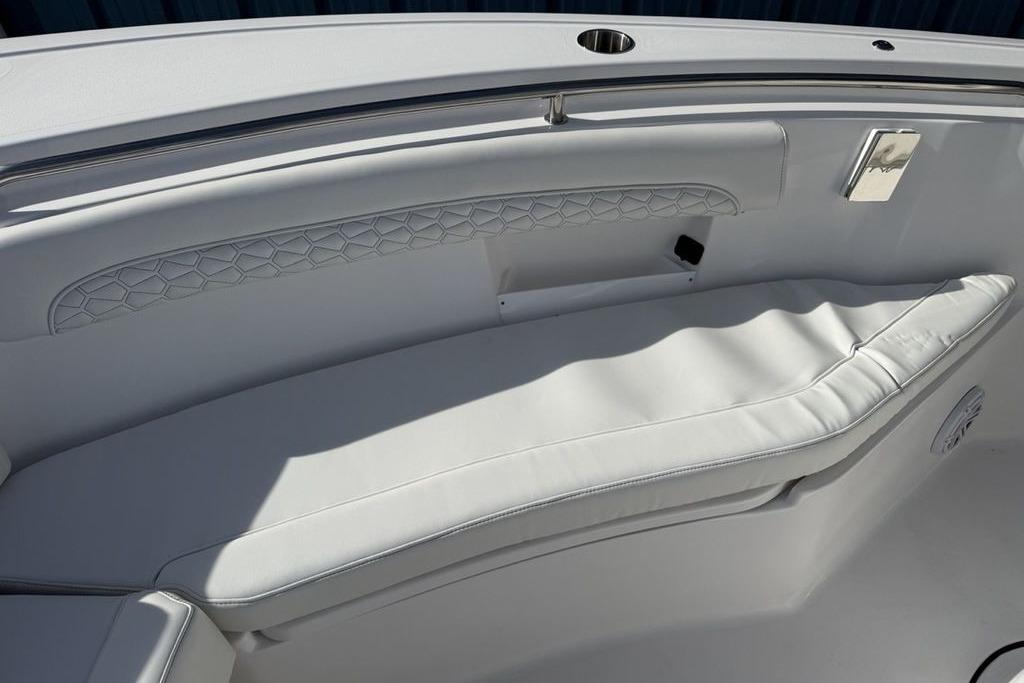 2026 Tidewater 232 LXF boat interior with white cushioned seating and elegant design.