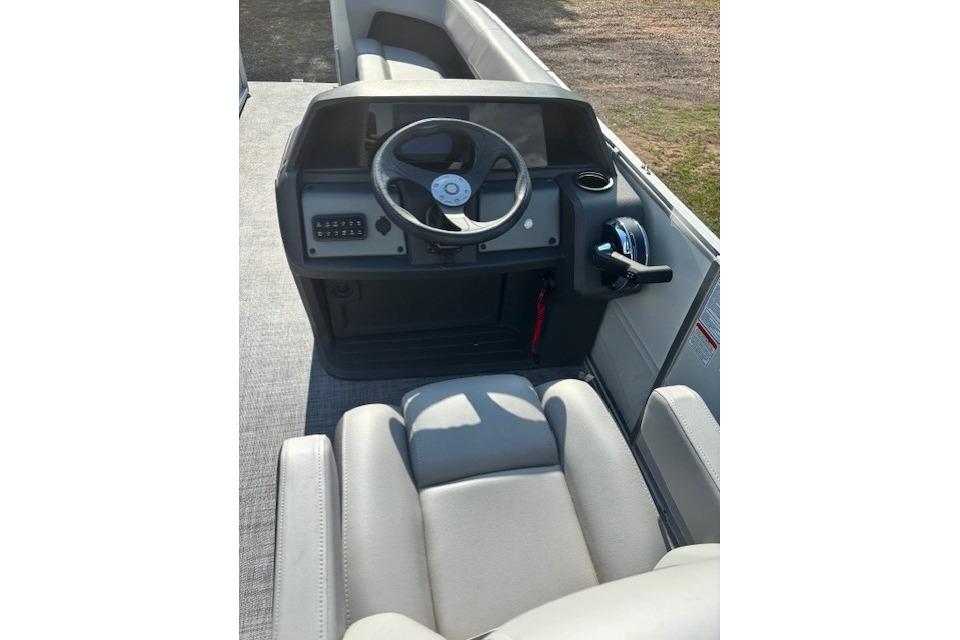 2026 Sun Tracker Party Barge 18 DLX helm with steering wheel and controls.