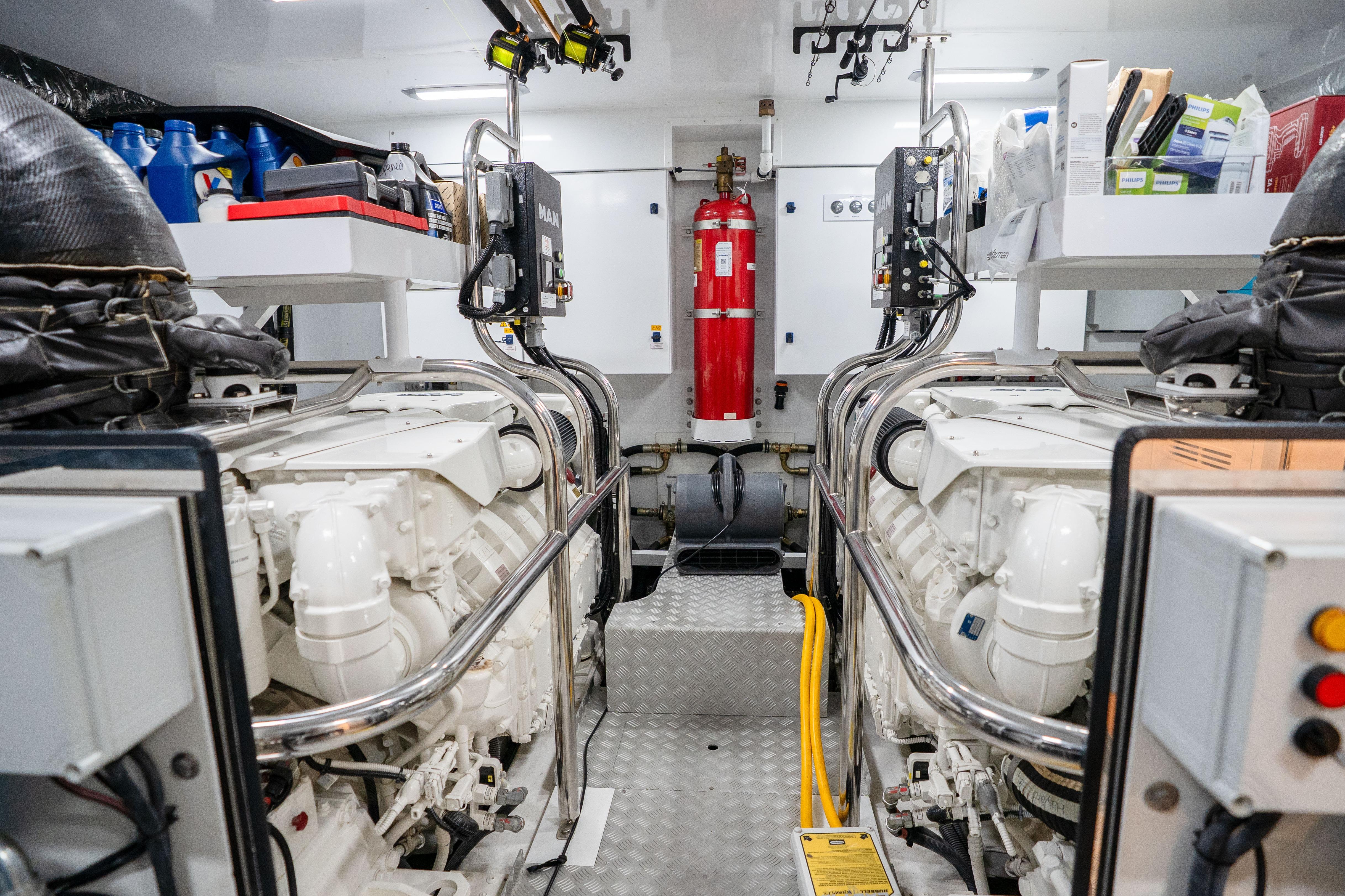 Engine room of 2020 Princess Y85 yacht with dual engines and safety equipment.